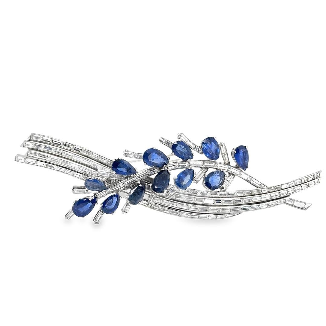 Magnificent brooch hand crafted in platinum. The brooch depicts a floral leaf and is highlighted with both natural baguette diamonds and blue ceylon sapphires. 
Four rows 4