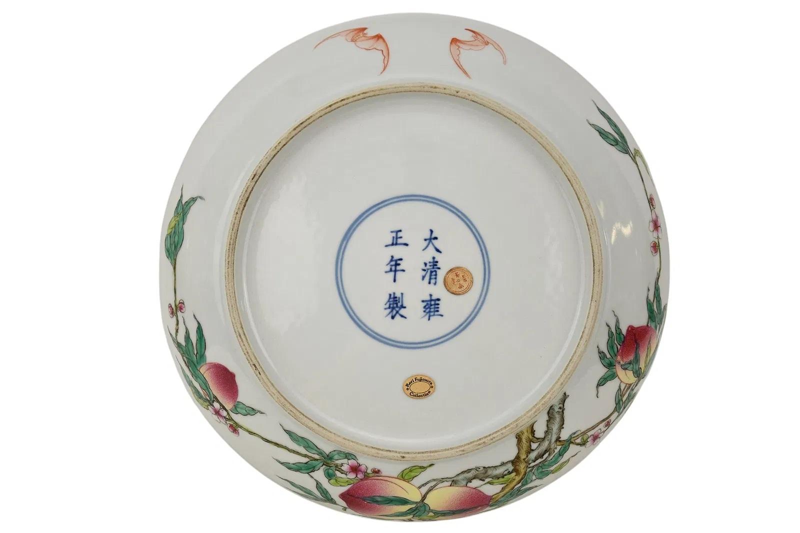 A fine famille rose 'peach' dish or charger , with Yongzheng six-character mark within double square on base

the porcelain dish of thin translucent sides, nicely enameled on the interior with branches bearing five ripe peaches rendered in shaded