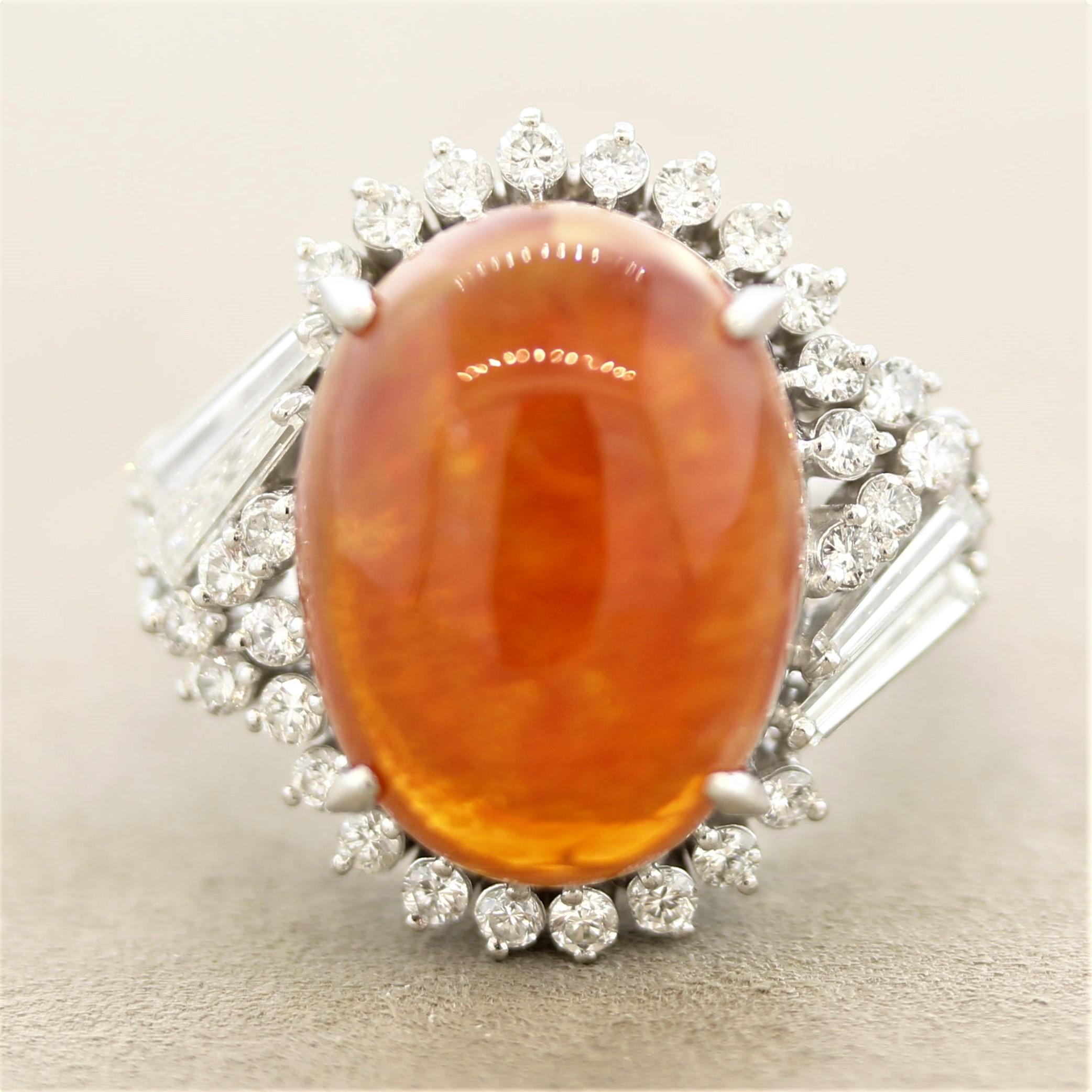 A special ring featuring a gem-quality rich orangey-red fire opal weighing 10.92 carats. It has excellent play-of-color as strong flashes of green, yellow, orange, and red can all be seen across the stone. It is accented by 1.09 carats of diamonds