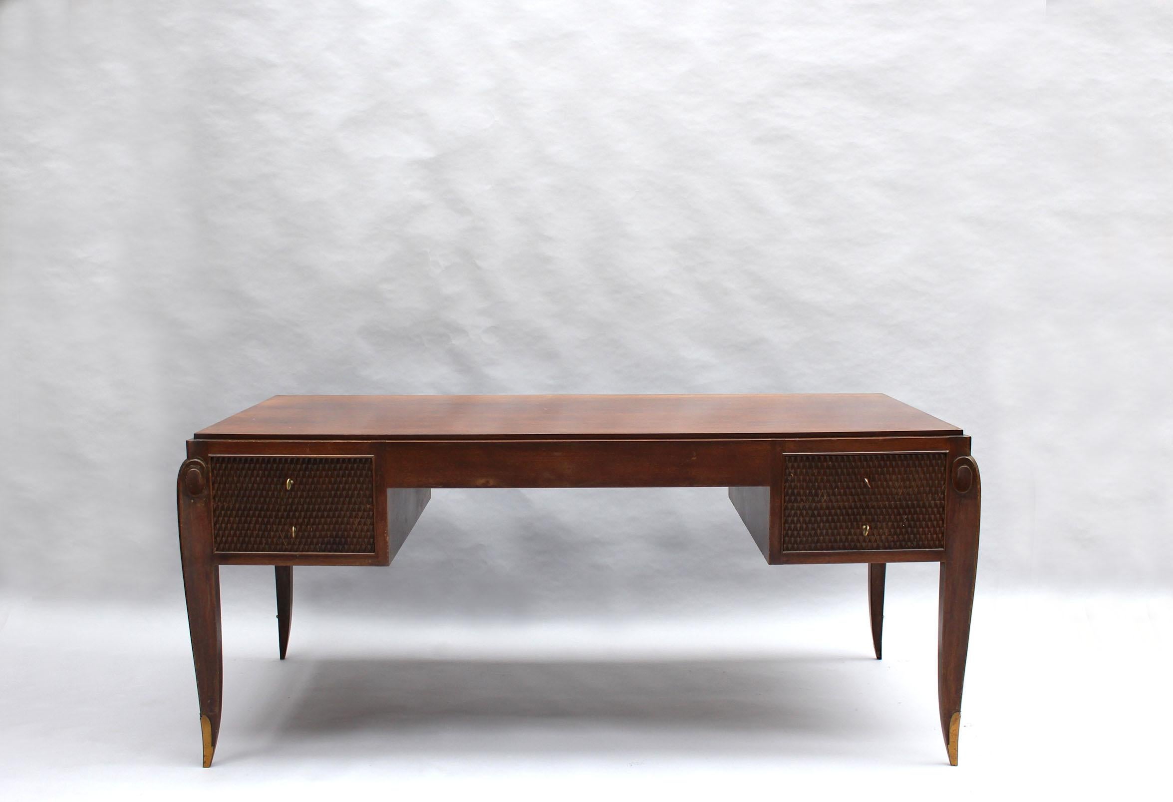 Jean Pascaud (1903-1996) - A fine French art deco walnut stained desk and cabinet / armoire.
The desk has four drawers with a carved diamond pattern and four scroll legs with bronze sabots.
The cabinet also has a carved diamond pattern that frames