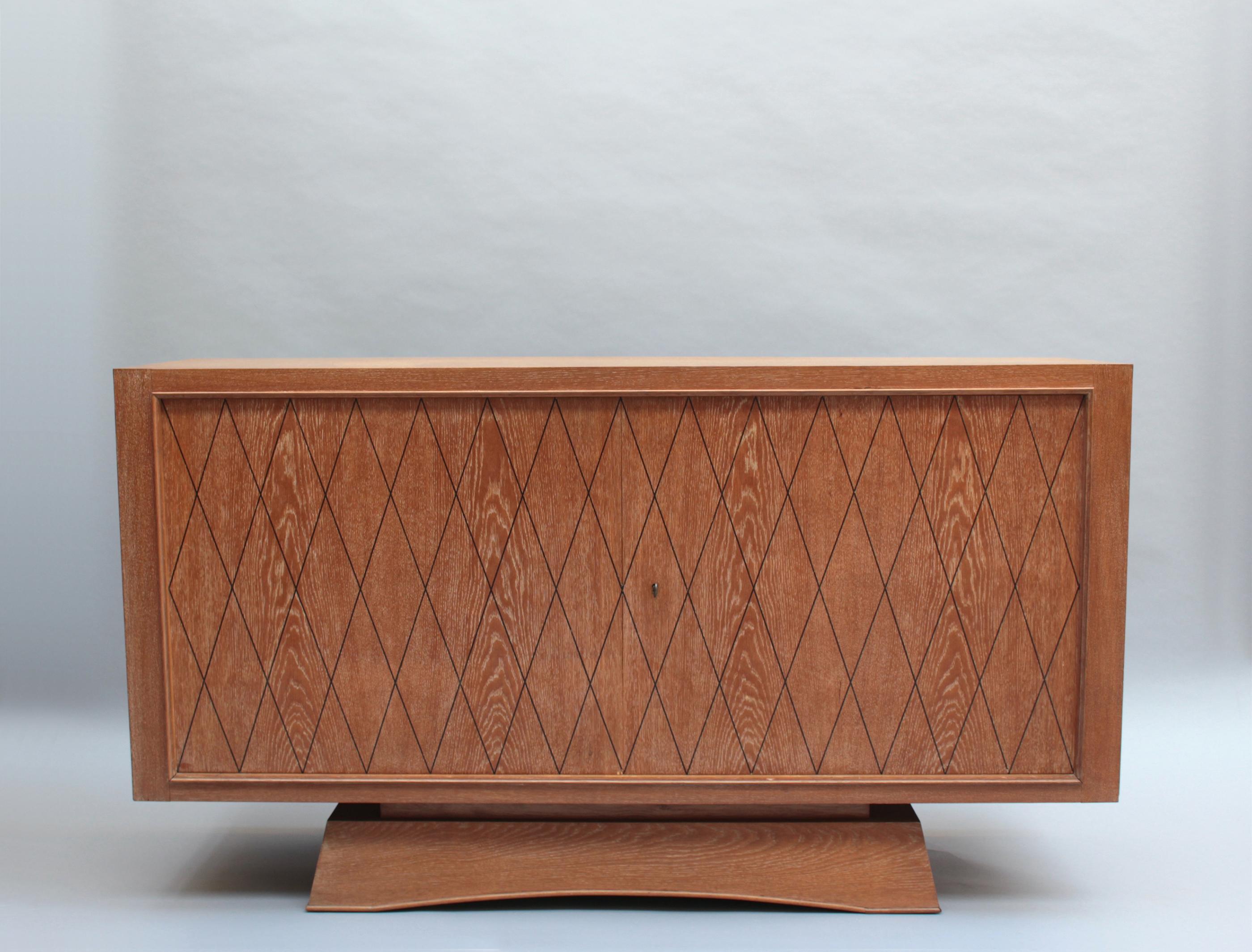 A fine French Mid-Century cerused oak sideboard with black diamond pattern inlays on the 2 doors.