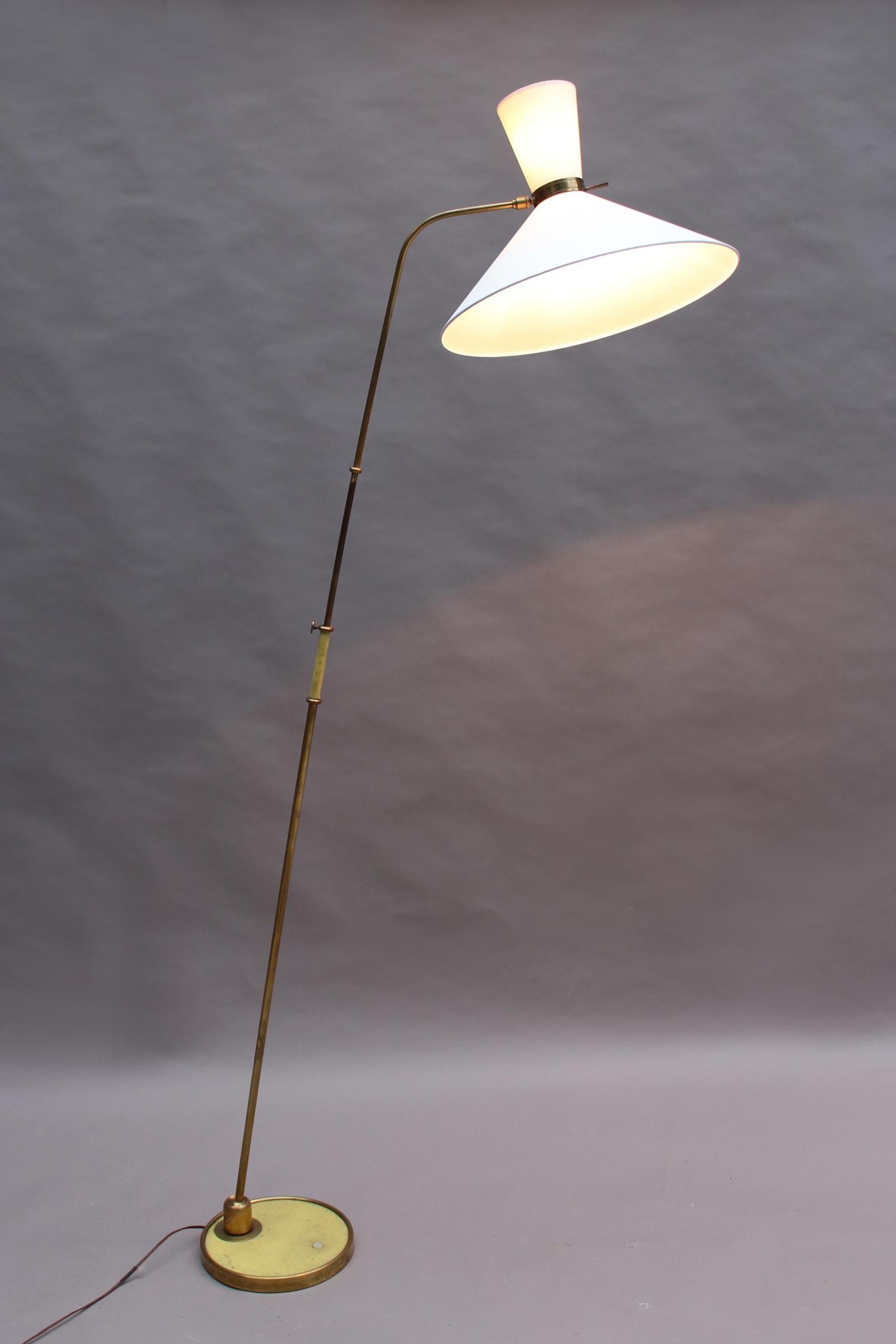 With a brass and yellow vinyl base and stem that hold a (remade) 2 bulb diabolo shade. Both stem and shade are adjustable.
Measures: Overall height is between 67