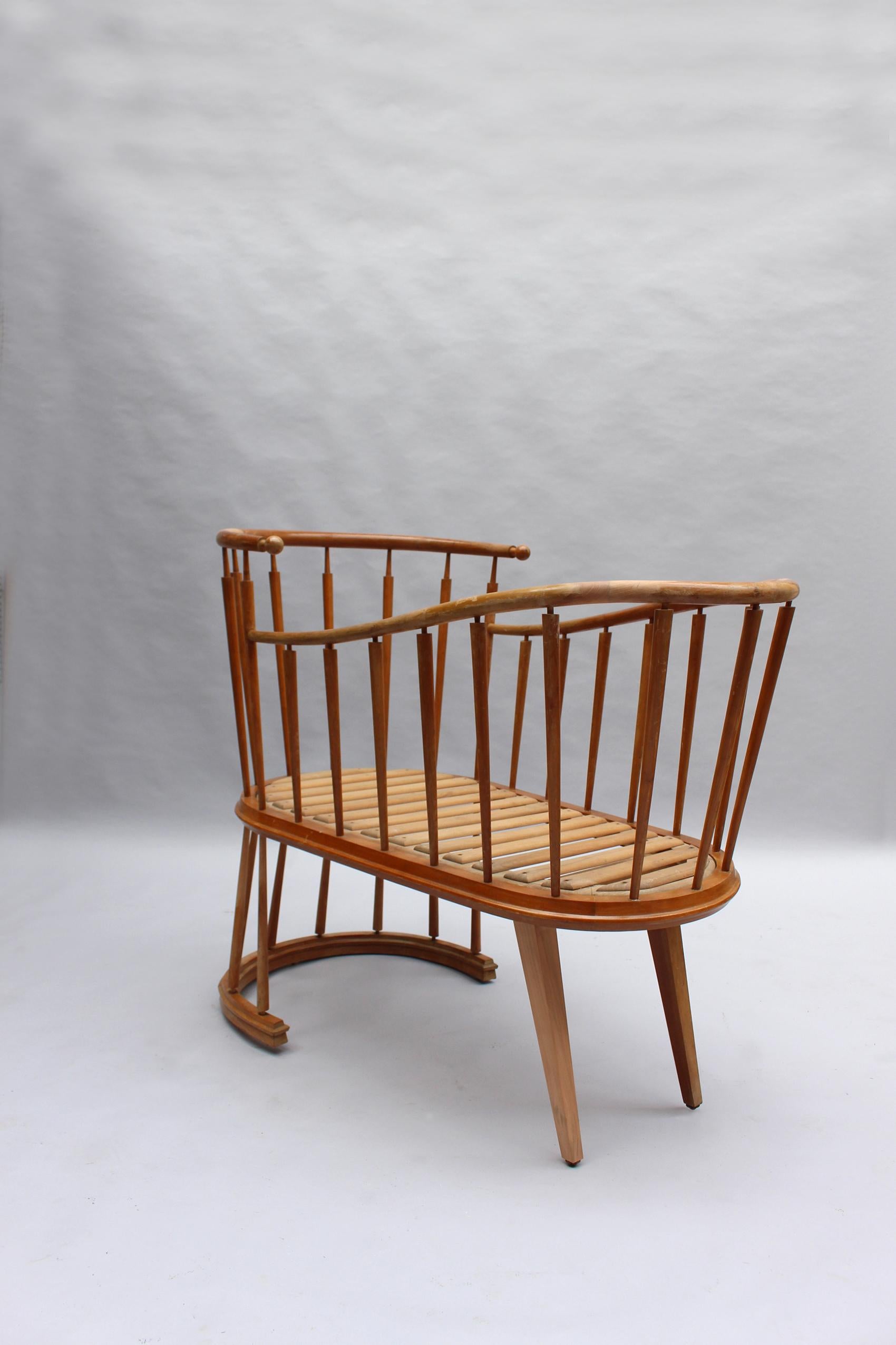 Unique piece, this solid cherry wood cradle was designed by Max Ingrand for his own children.