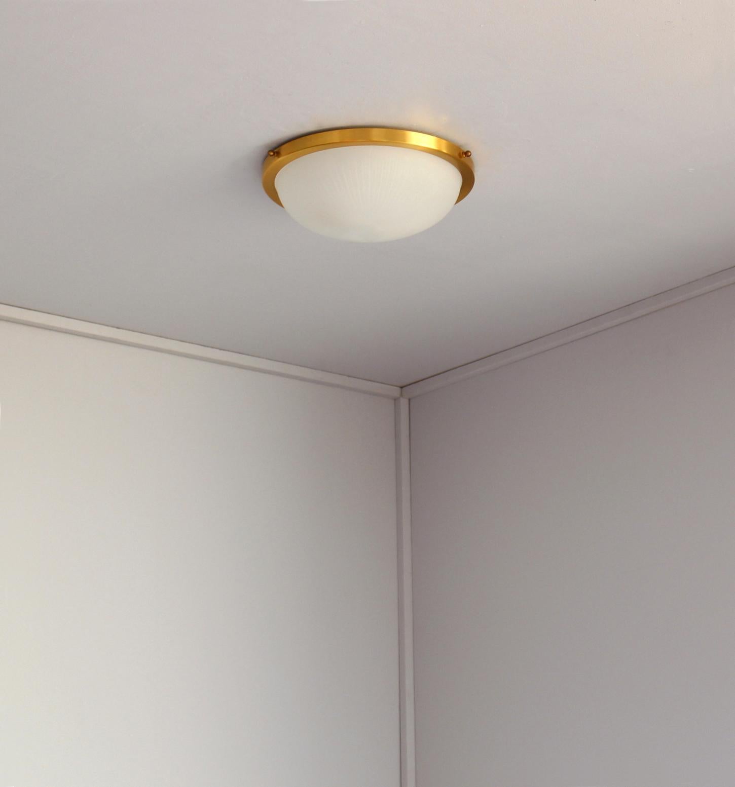 Jean Perzel - A fine French midcentury ceiling light with a satin brushed circular brass structure that holds a fluted frosted glass bowl diffuser.
Signed.