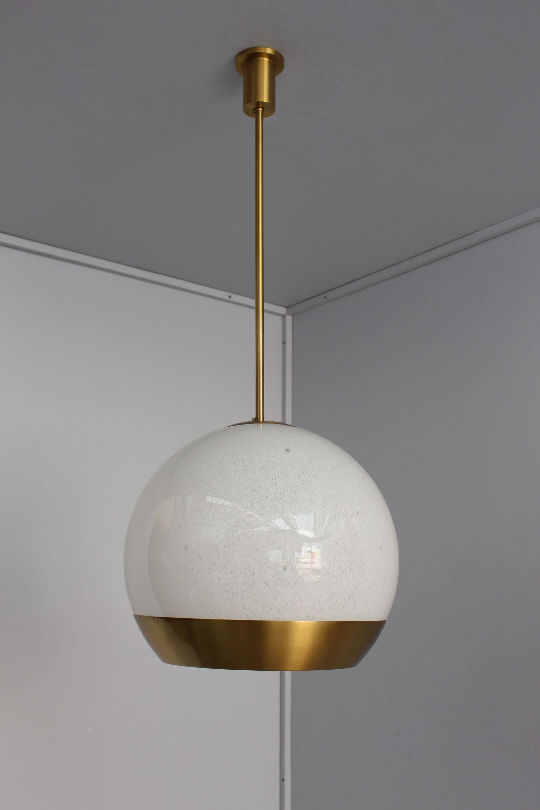 With a bronze cylindrical rod and canopy, a bubbly white glass bowl mounted on a bronze frame that holds a white opaline glass diffuser (which is easy to remove in order to replace the bulbs).
Signed.
