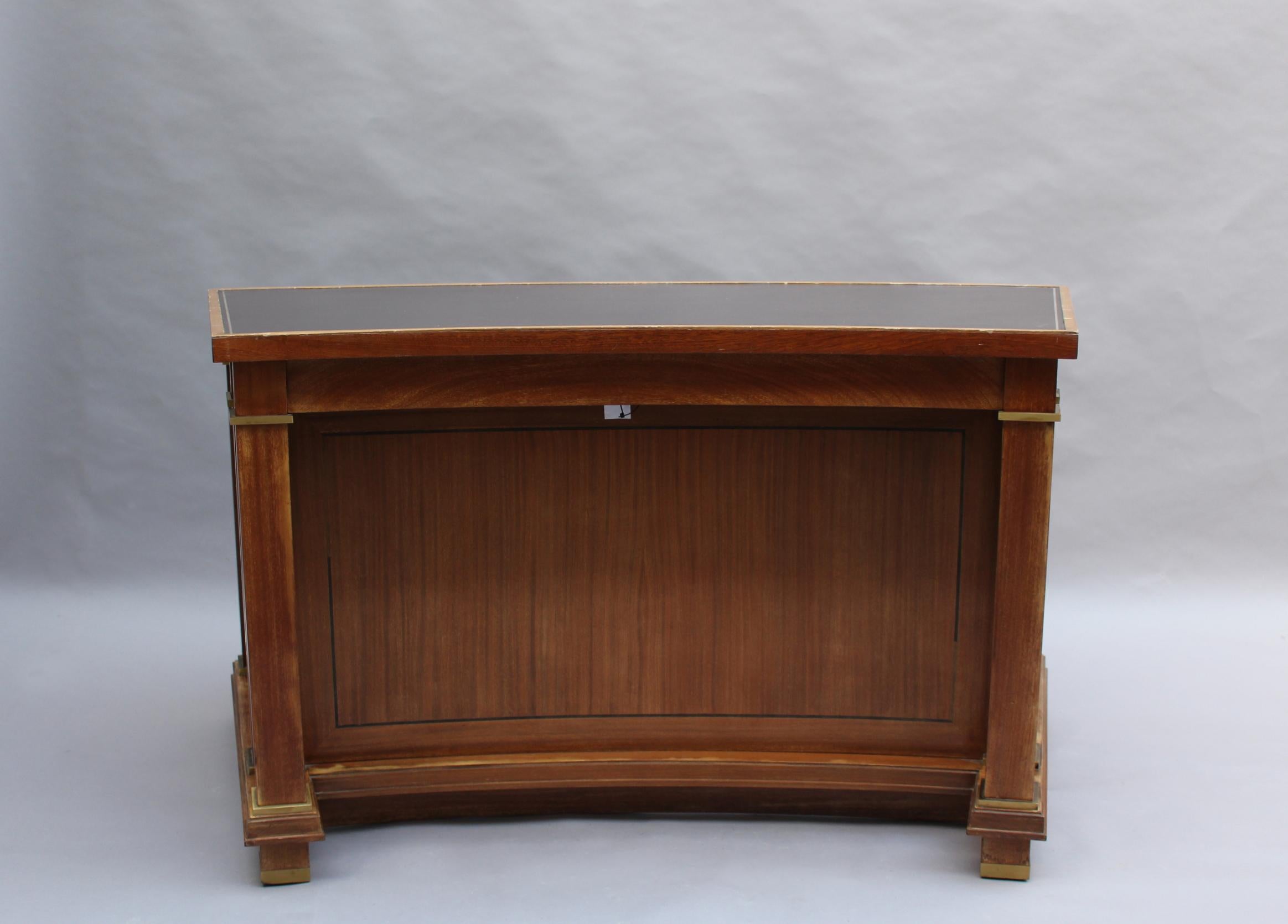 Jacques Adnet: A fine French midcentury mahogany curved desk with a leather top and bronze details.
Provenance: Palais des Consuls of Rouen, France.
2 rectangular desks with a similar design and from the same provenance are also available (ref. #