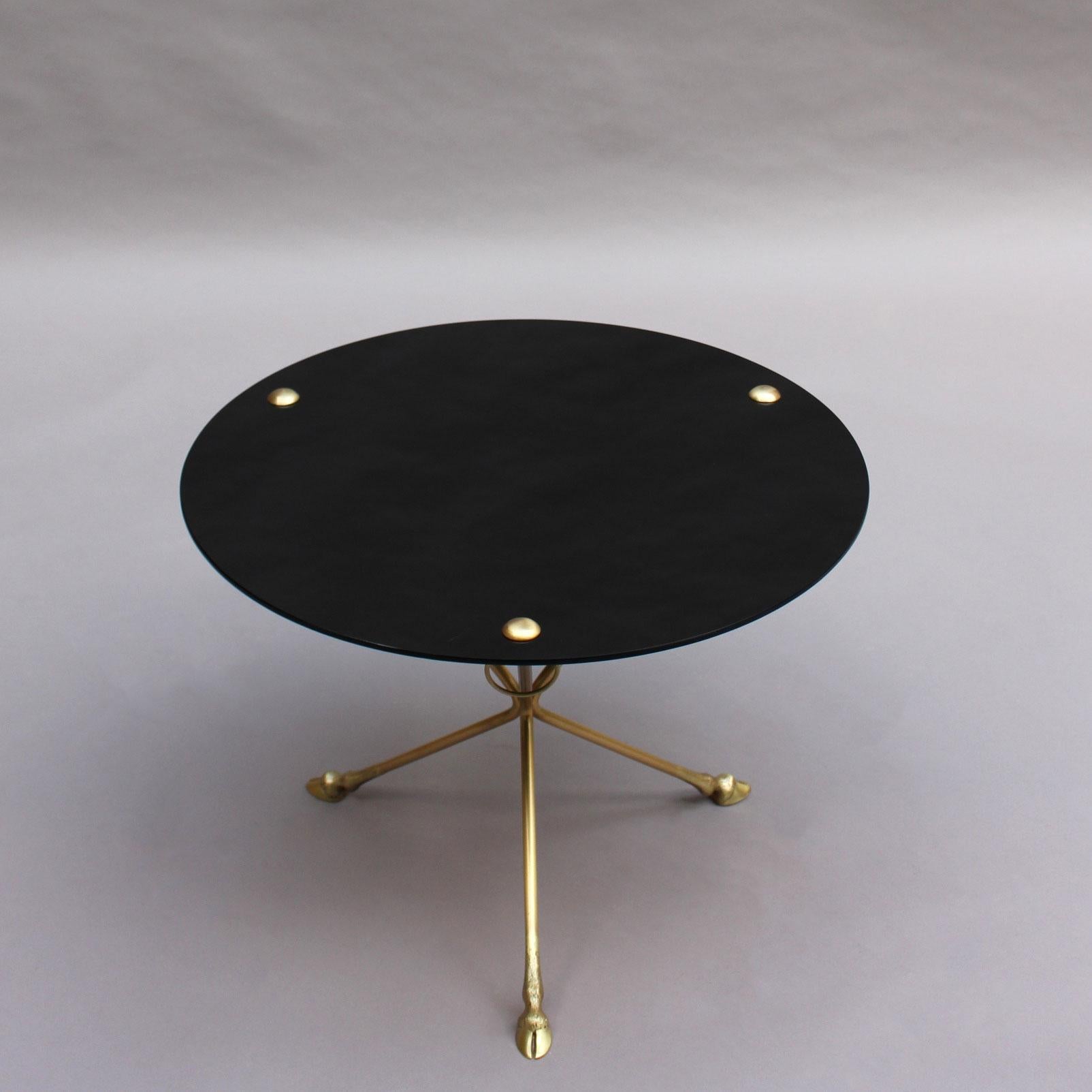 A fine French mid-century gueridon with a bronze tripod base finished with 