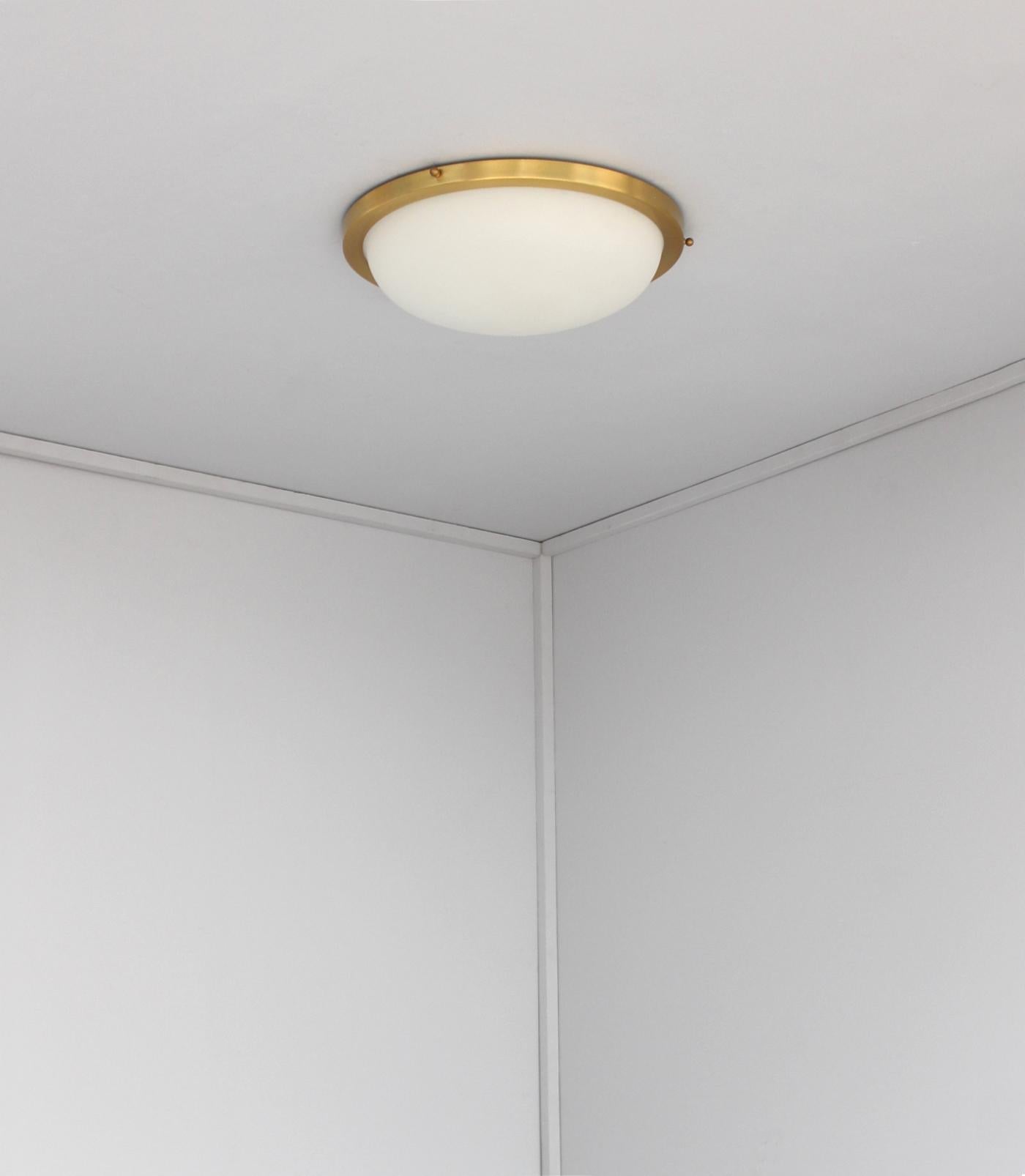 Jean Perzel - A fine midcentury ceiling light made with a circular brass structure that holds a fluted white opaline frosted glass bowl diffuser.
Signed.