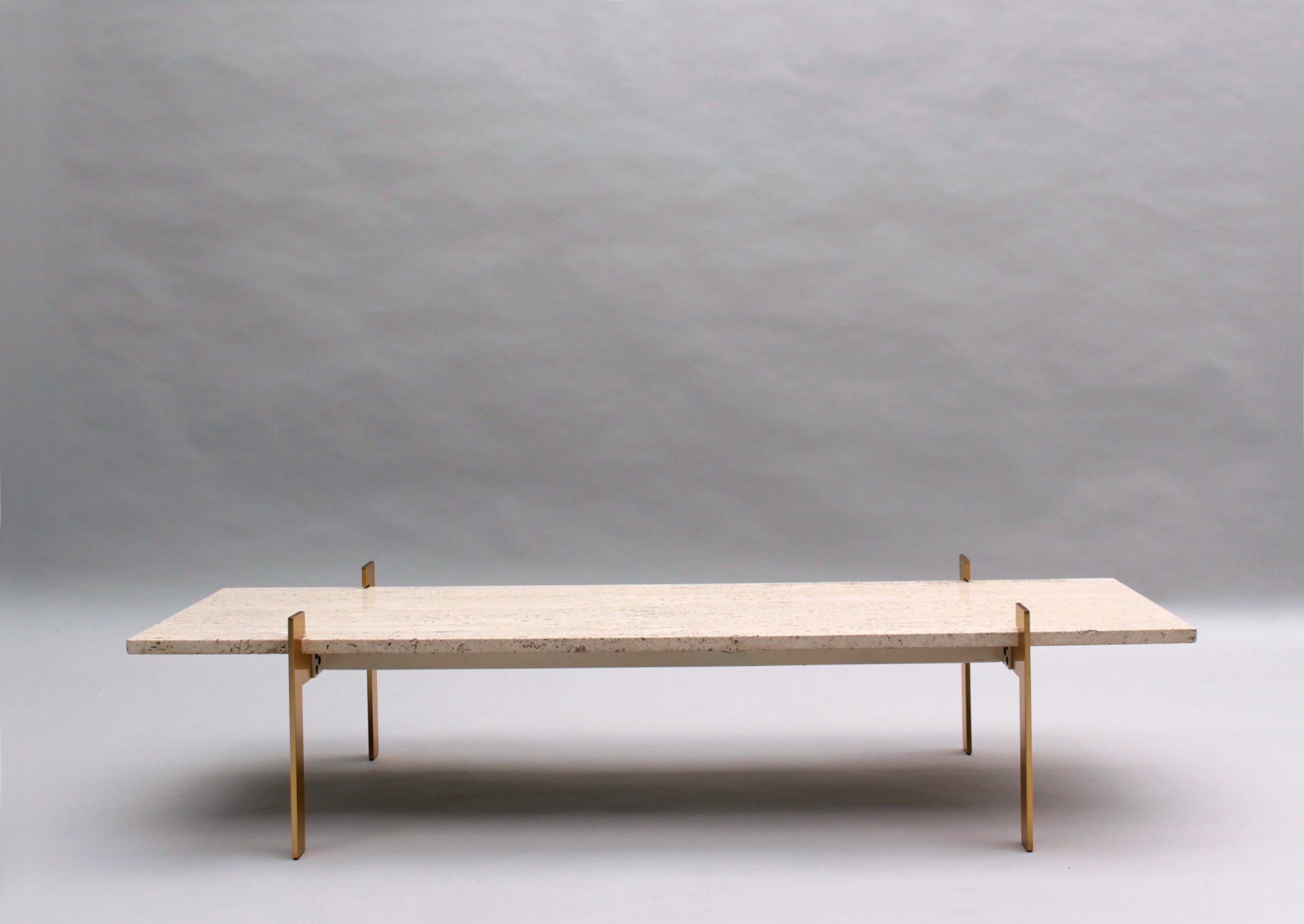 A fine French 1960s travertine top coffee table with a four brass legs base.

Travertine top is  W 53