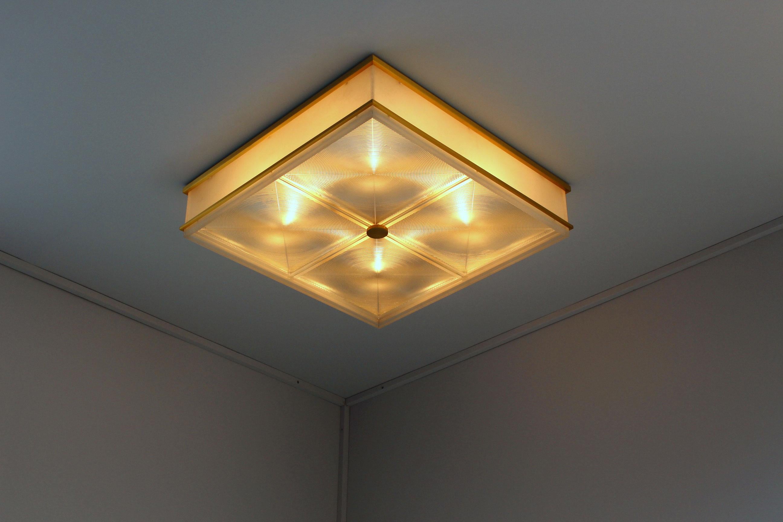 Jules Leleu: A fine French Mid-Century Ceiling light with a bronze frame, four lateral Lucite diffusers and four Holophane glass bottom diffusers.
Documentation: 