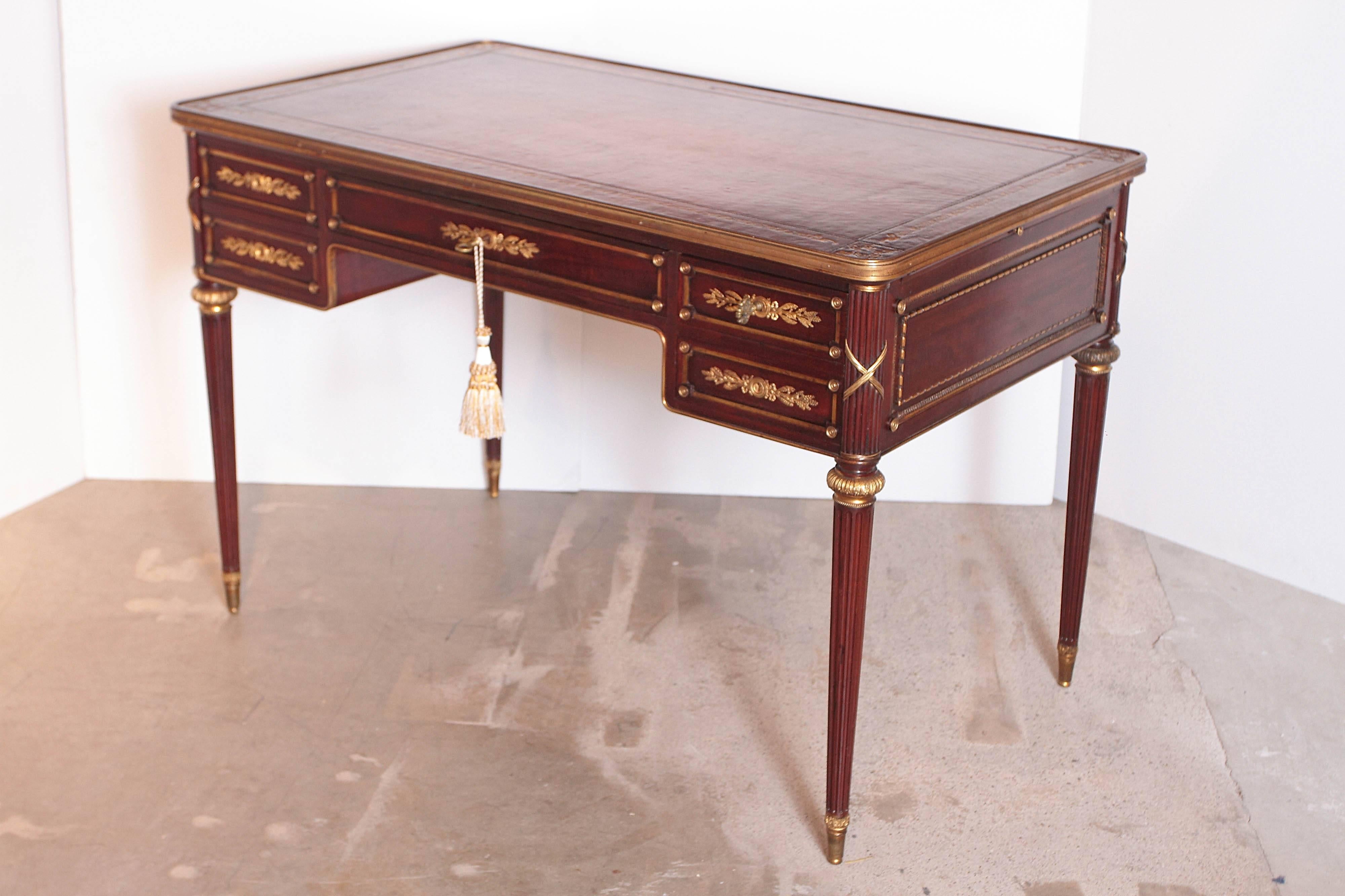 Fine French late 19th century Louis XVI leather top writing desk. Gilt bronze detailing. Two leather pull outs. 
Signed in the lock plate A Chevrie Paris.