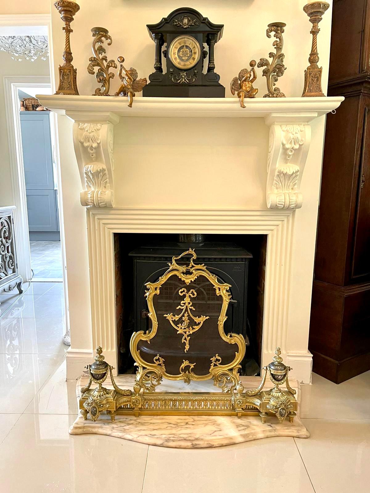 Fine French antique classical gilt bronze ormolu extending fender having outstanding slit, helix and star decoration to the front with a pair of fantastic two tone bronze urns with cameo intaglios and finial tops with ornate shaped feet. Stamped to
