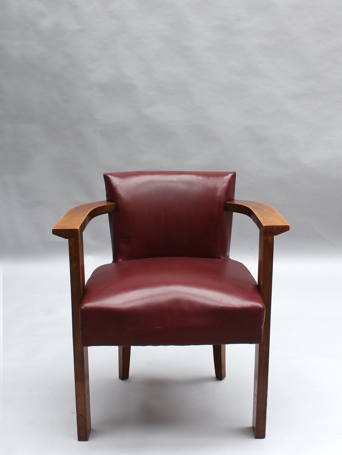 A fine French 1930s desk armchair in solid stained beech wood with flat arms.