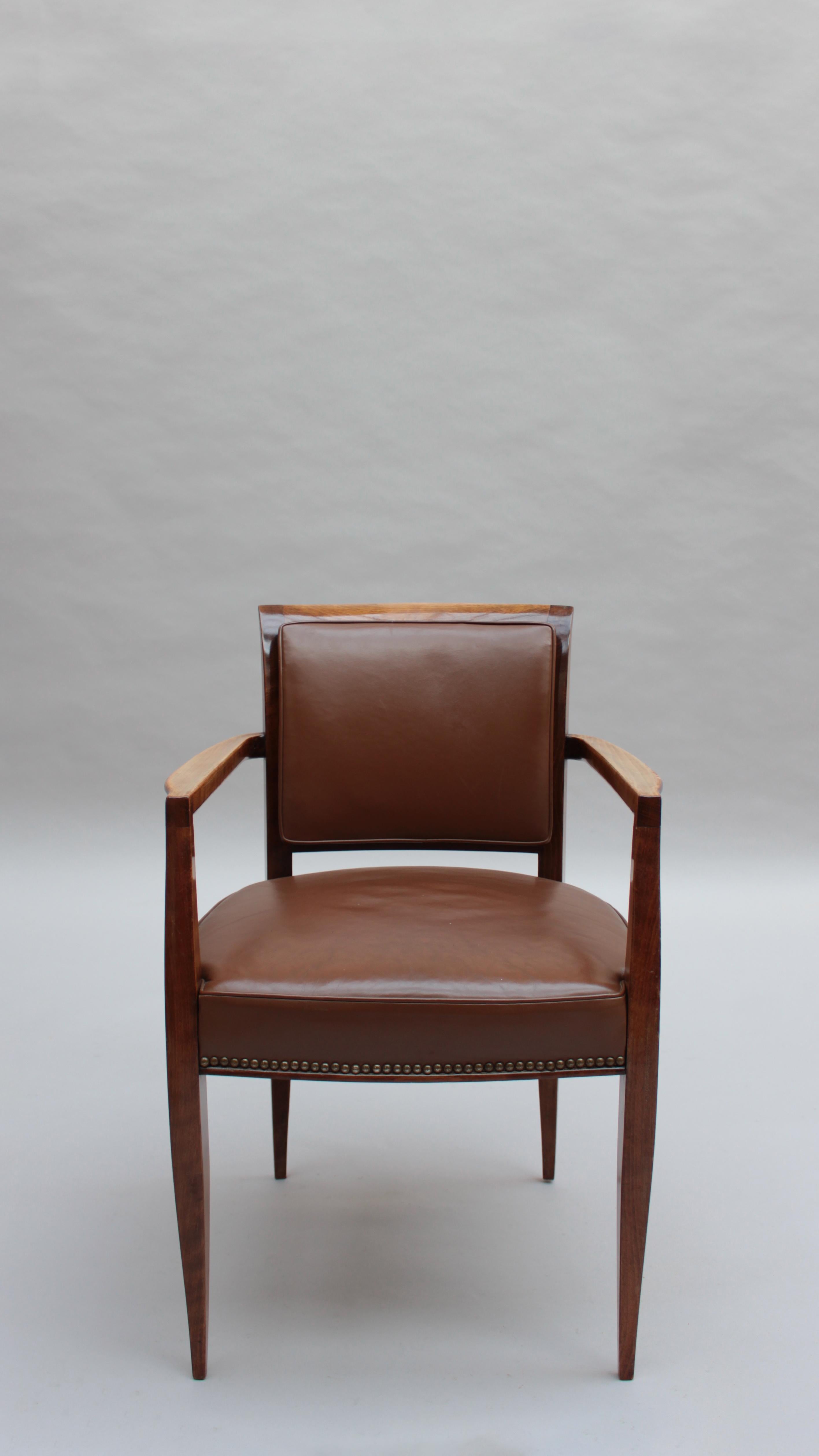 A fine French 1930s desk armchair in solid stained beech wood.