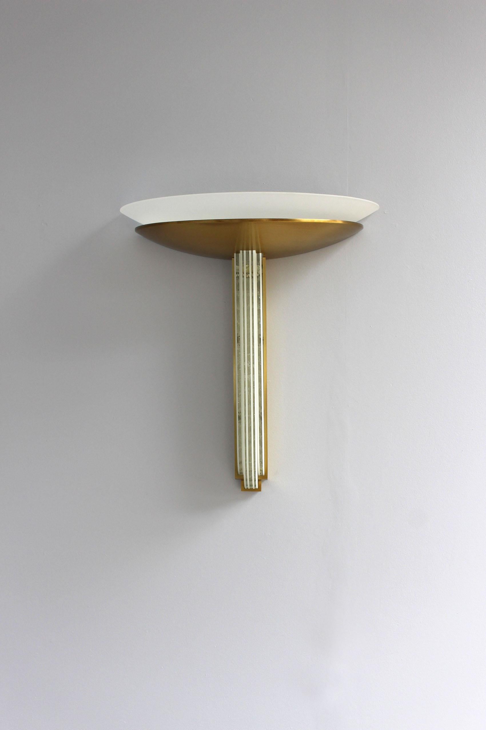 Jean Perzel - A fine French Art Deco sconce made with vertical diamond cut-glass slabs outlined by a bronze mount and a bronze bowl that supports a white frosted glass diffuser.
This wall light adorned the grand luxury cabin on the cruise liner