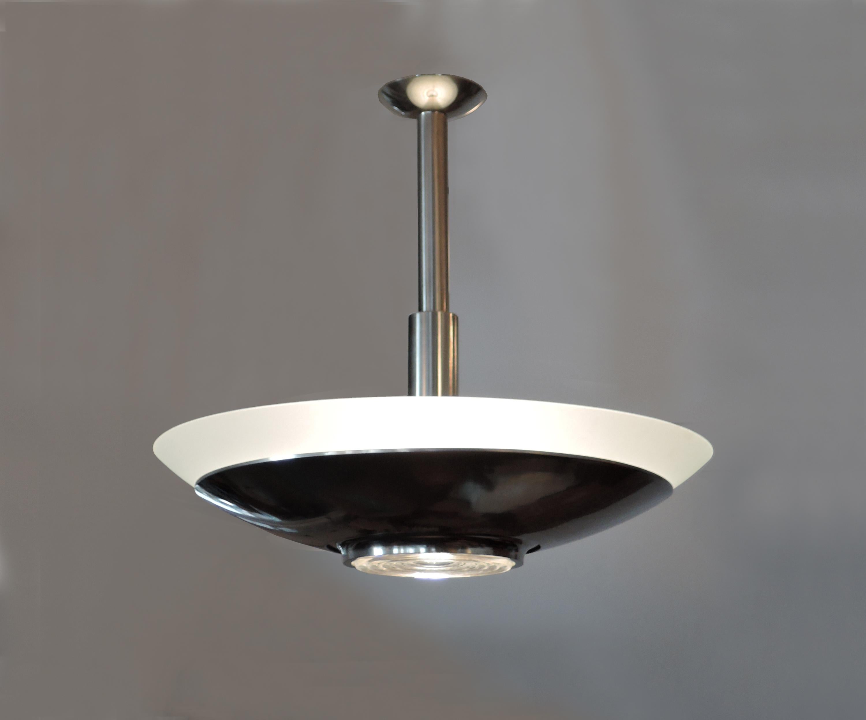 Jean Perzel - A fine French Art Deco chandelier with a convex frosted glass diffuser sitting on a chrome bowl and a center prismatic glass lens.
US re-wired.