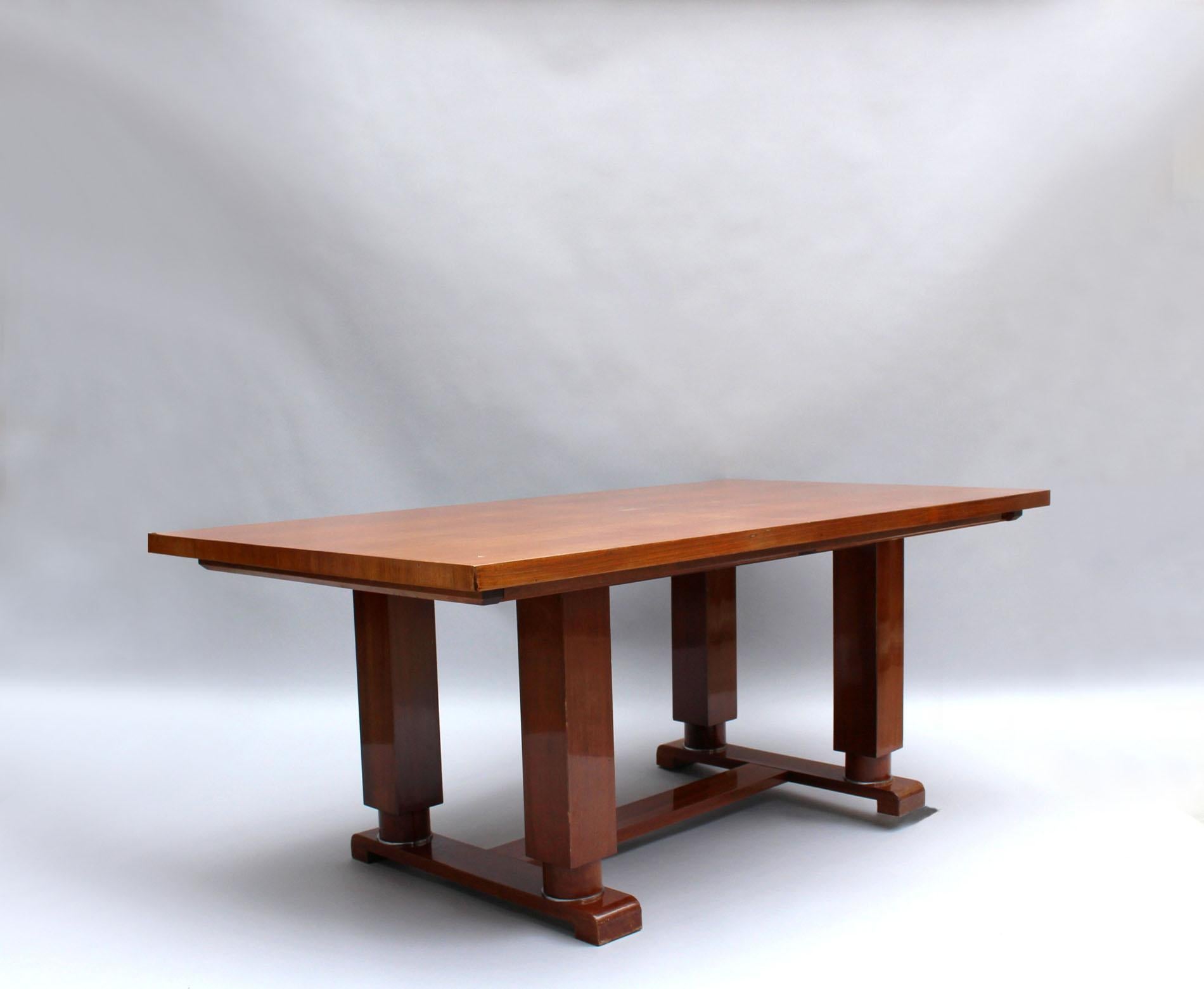 A fine French Art Deco extendable dining table, in walnut with a 4 legs pedestal base and bronze details. Signed

Length with the 2 matching end leaves is 107 3/4