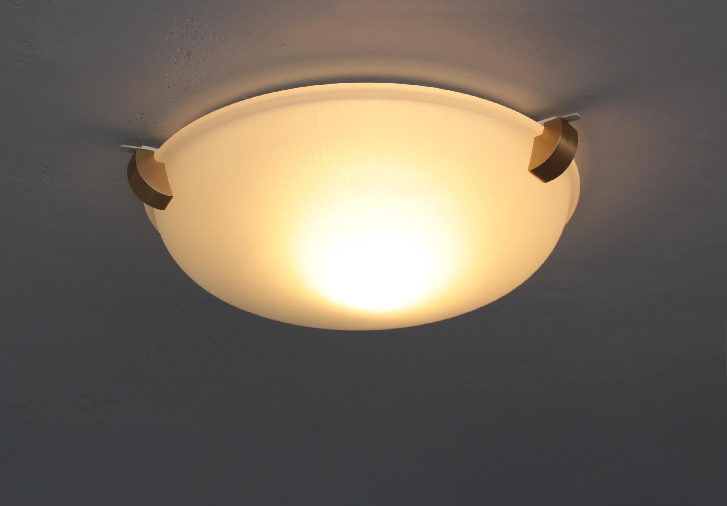 Atelier Jean Perzel - A fine French Art Deco flush mount ceiling fixtures or wall light with a round frosted glass shade supported by three bronze studs.