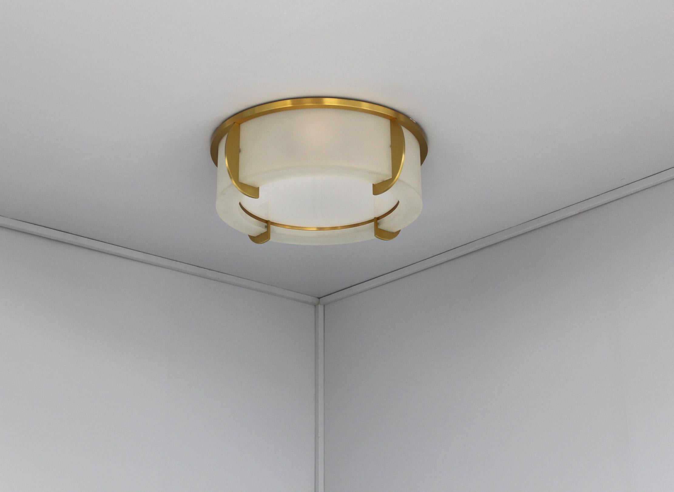 Mounted on a bronze crown-shaped frame that holds the frosted glass diffusers. The horizontal round enameled white glass diffuser is removable in order to change the bulbs.

 