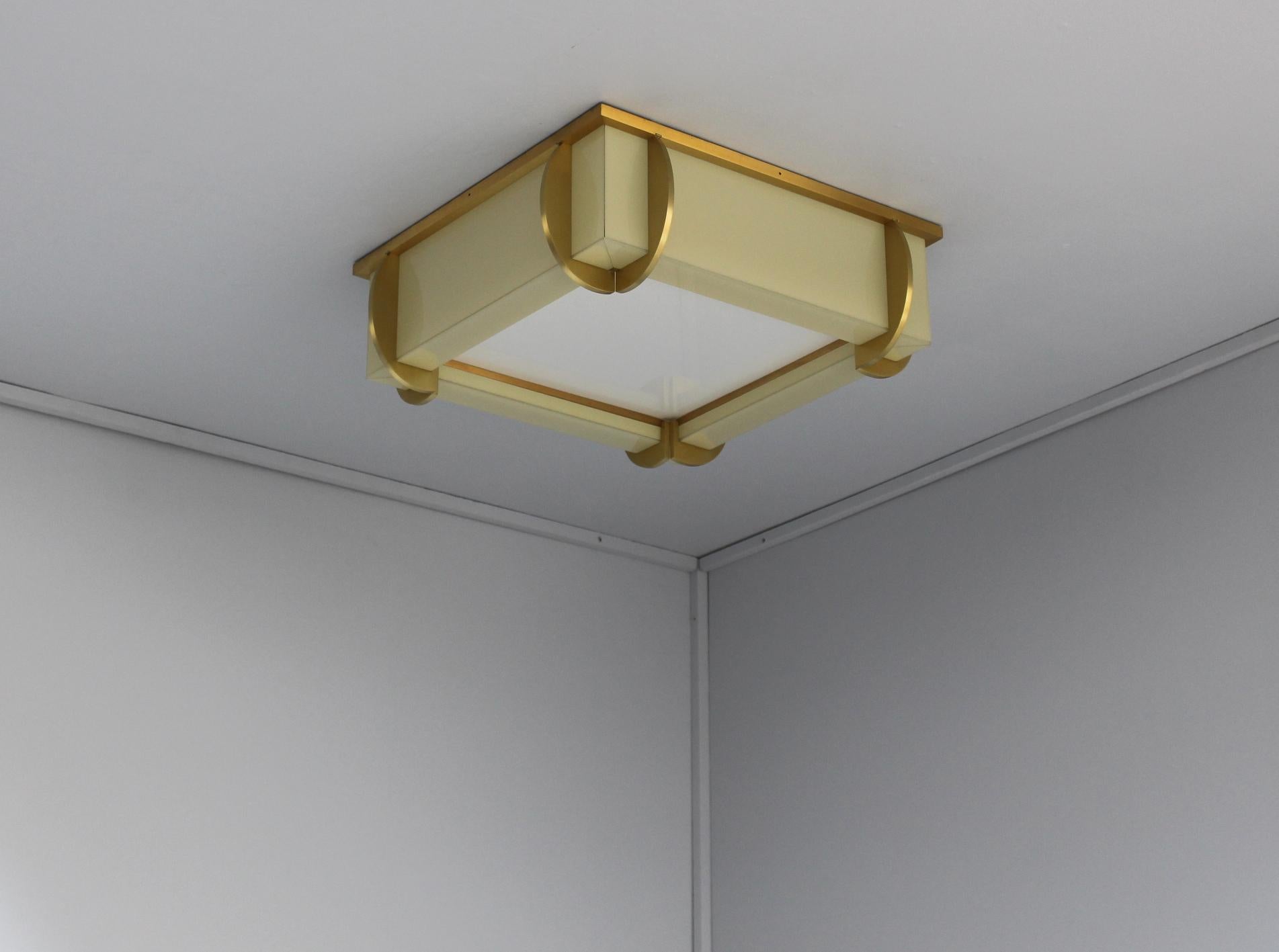 Mounted on a bronze square frame that holds the enameled glass diffusers. The square bottom glass diffuser is removable for bulb replacement.

