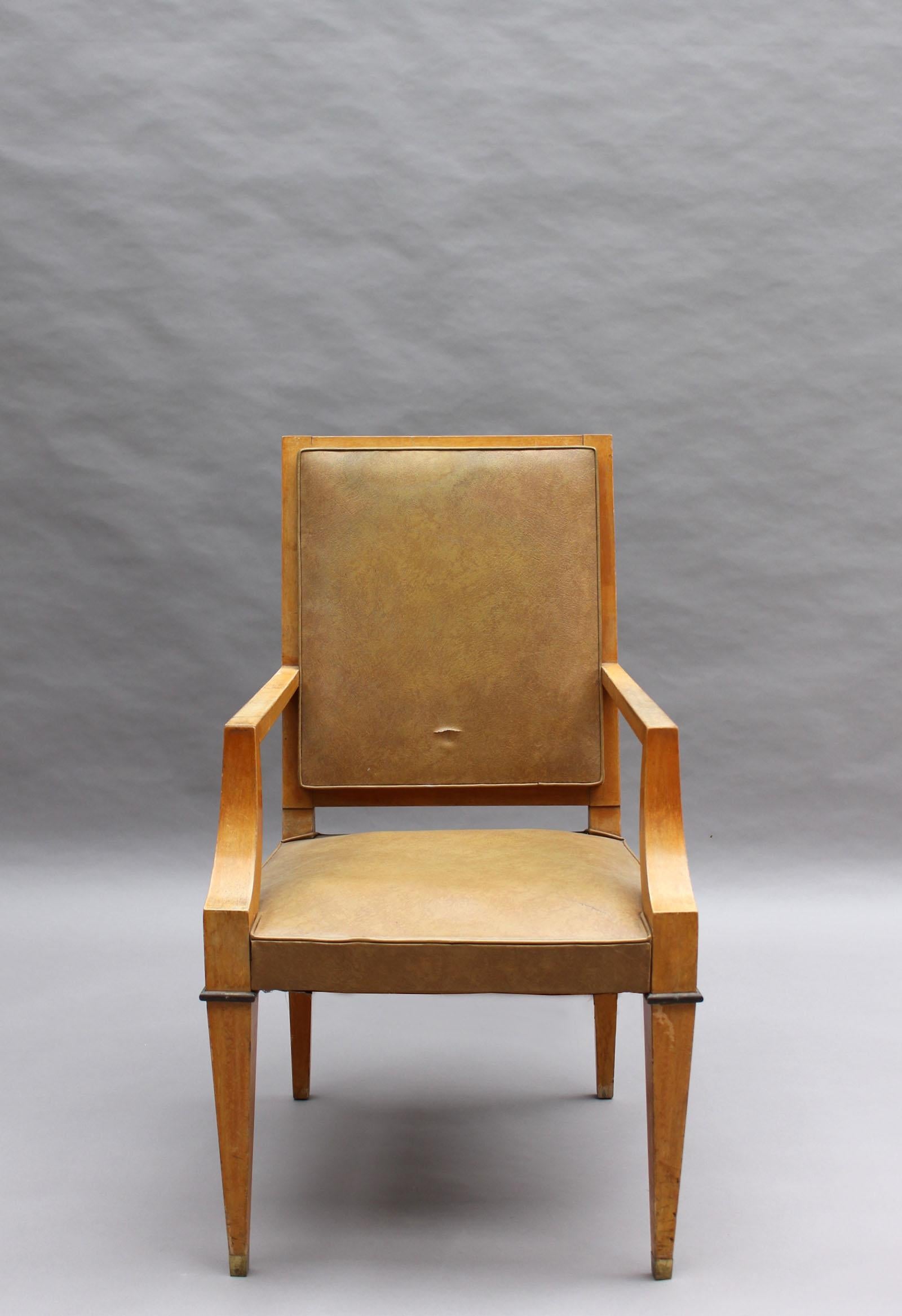A fine French 1930s desk chair in solid maple with bronze details.