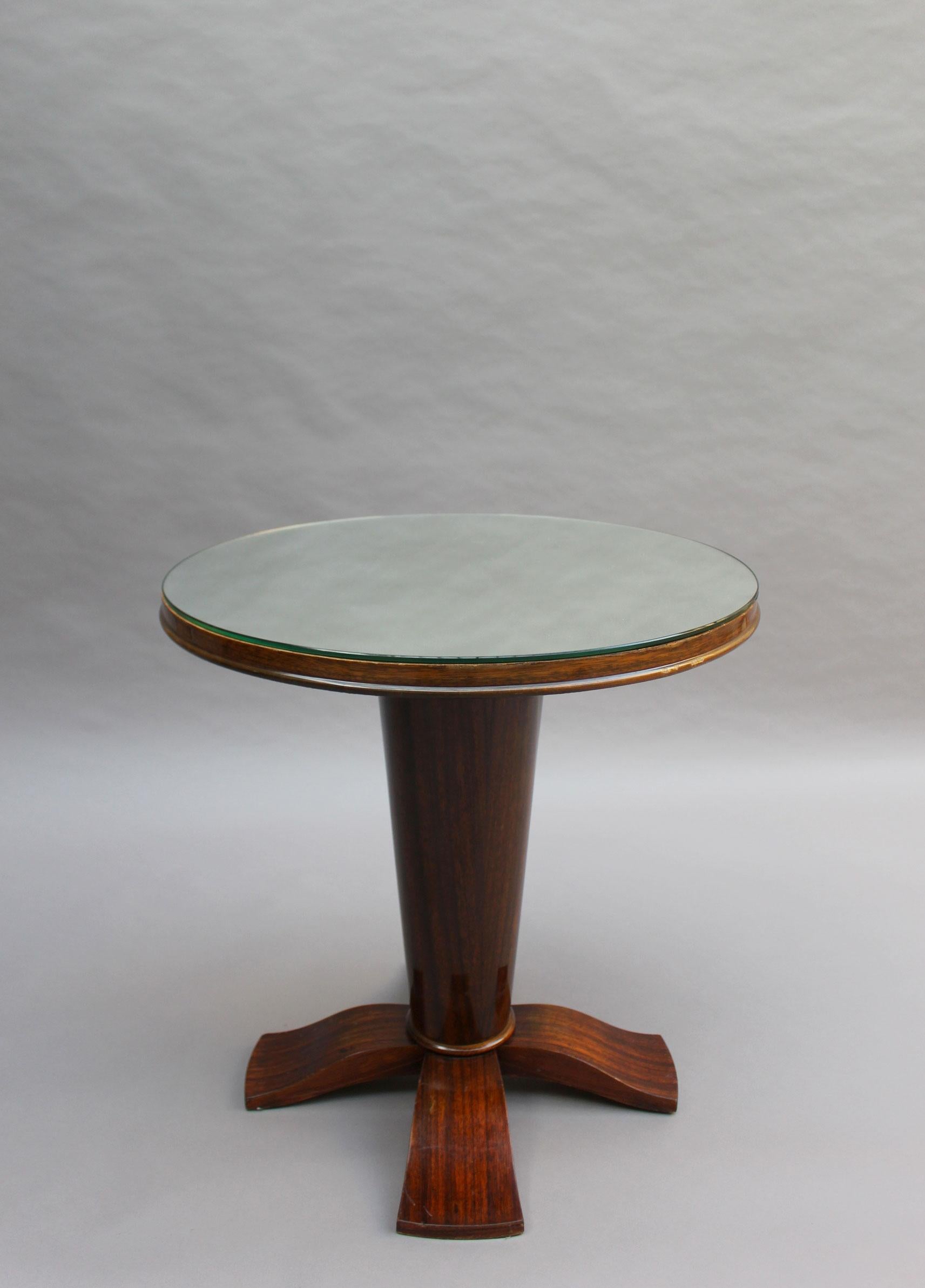 With a conical base and 4 curved feet.
  
