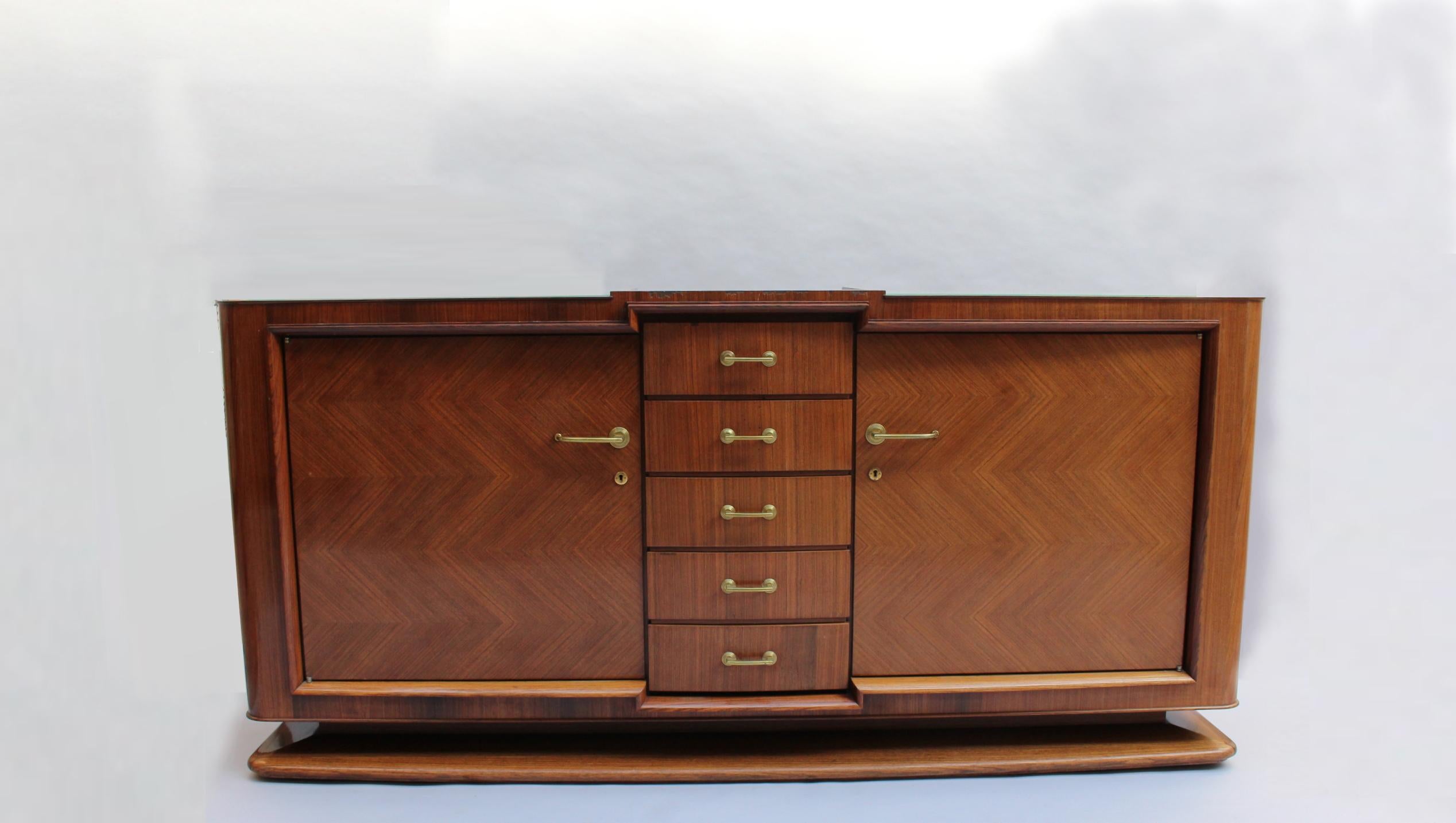 A fine French Art Deco palisander sideboard by Maxime Old, with 2 doors, 5 drawers and bronze hardware. Signed
A matching dining table, 8 chairs (6 side and 2 arm), and a dry bar are also available, see pictures.
