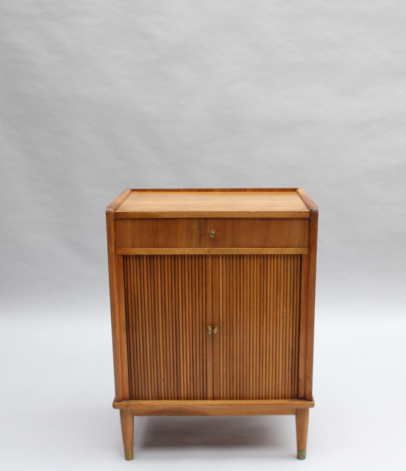 A fine French 1930s small music cabinet in walnut with 2 tambour doors, 1 drawer and bronze details.
Can also be used as a night stand or side table.