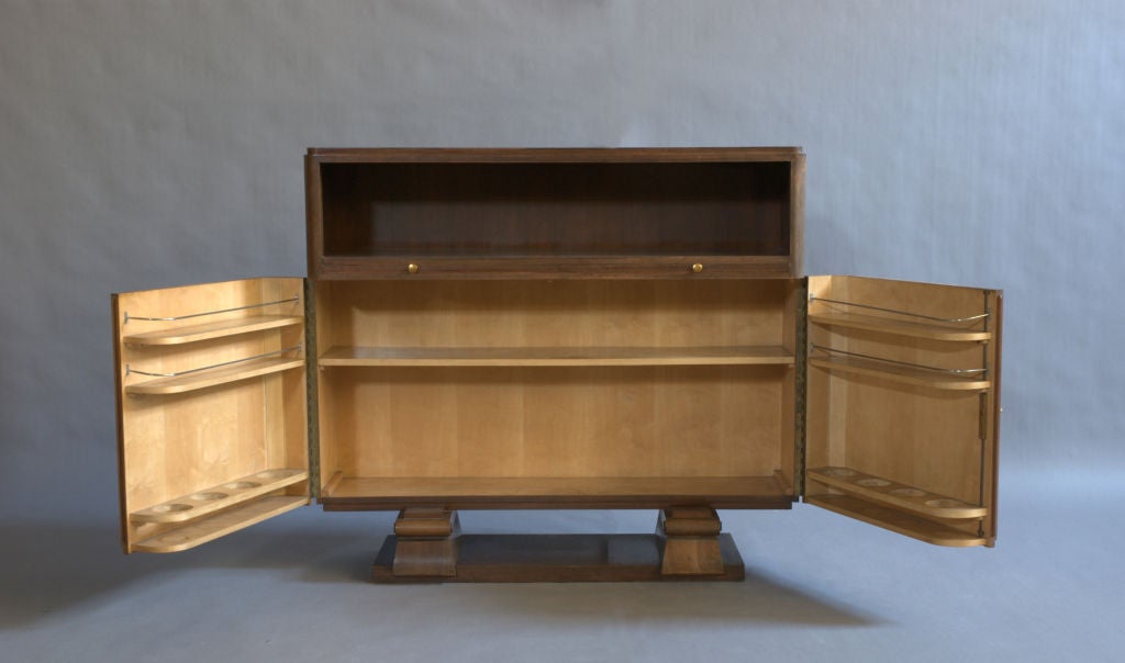 A Fine French Art Deco rosewood marquetry and mahogany bar with a pull-out mirrored tablet and brass details.