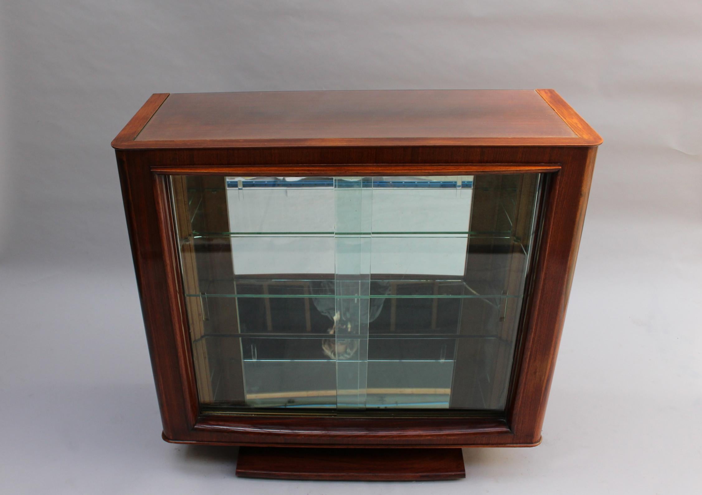 A fine French 1930s rosewood vitrine / bar by Maxime Old
with 2 sliding glass doors, a mirrored interior and glass shelves.
A sideboard, a dining table, 8 chairs (6 side + 2 arm) and another vitrine are also available -see pictures.