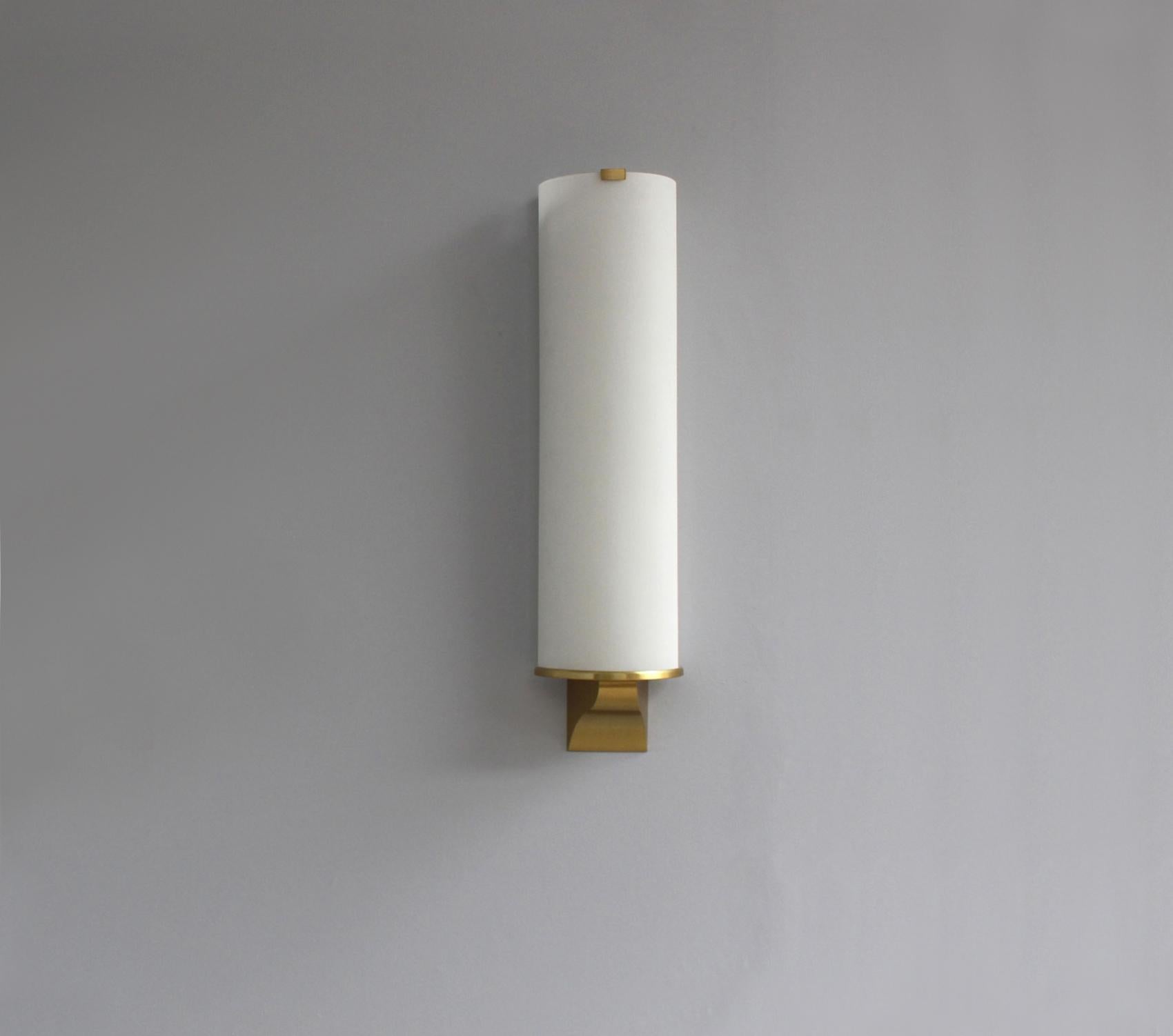 Fine French Art Deco semi cylinder shape wall light by Jean Perzel with a white frosted optical glass supported by a bronze mount.
