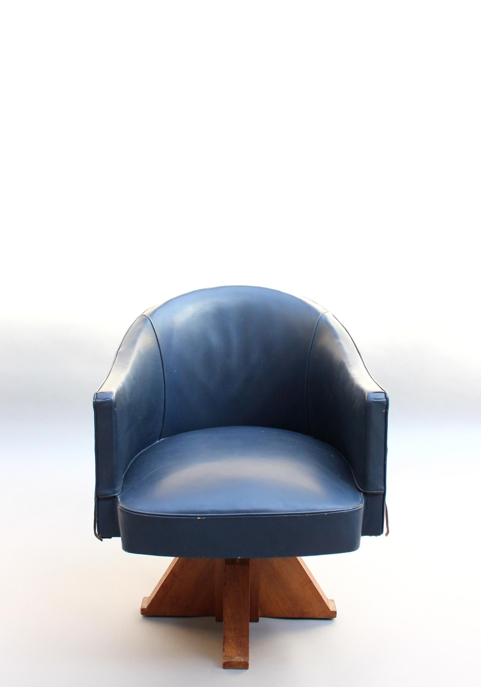 A fine French Art Deco swivel desk armchair on a walnut quadripod base by Leleu.
 