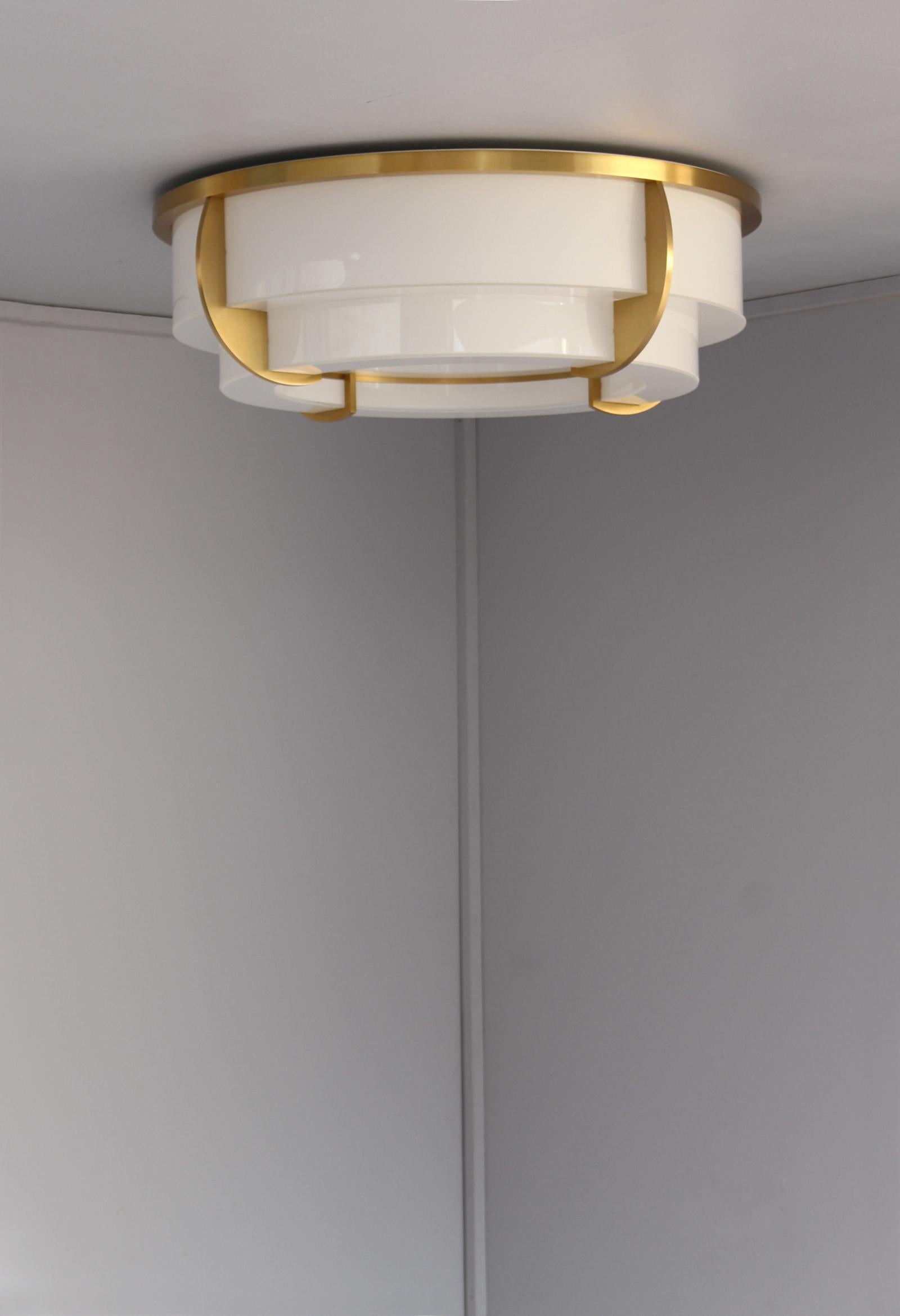 Jean Perzel - fine French Art Deco two-tiered round ceiling fixture with a gilded lacquered bronze frame which supports the bent and flat enameled white glass diffusers.
The flat bottom diffuser is removable in order to change the bulbs
This model