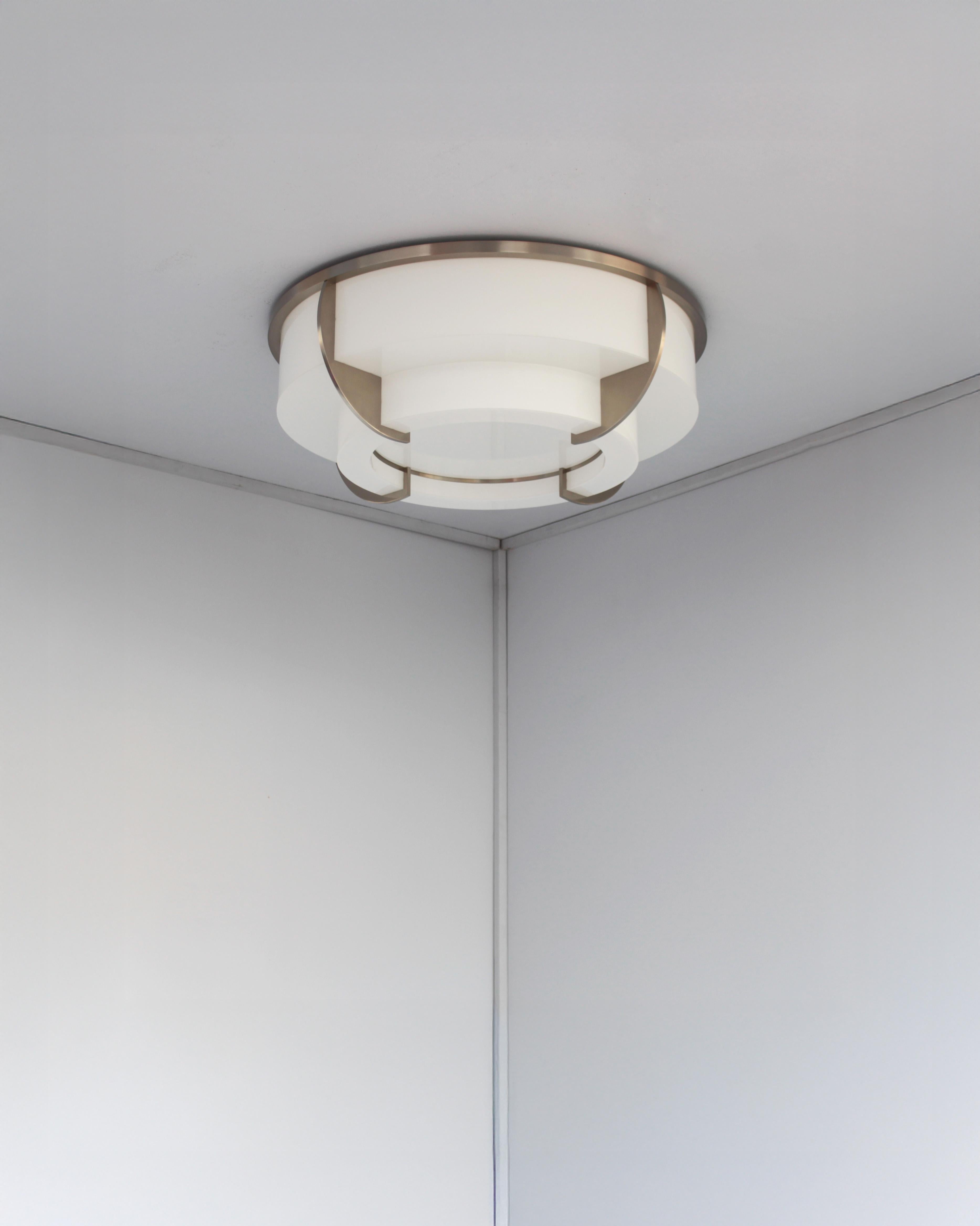 Jean Perzel - A fine French Art Deco two-tiered round ceiling fixture with a brushed nickel frame which supports the bent and flat enameled white glass diffusers.
The flat bottom diffuser is removable in order to change the bulbs
This model used to