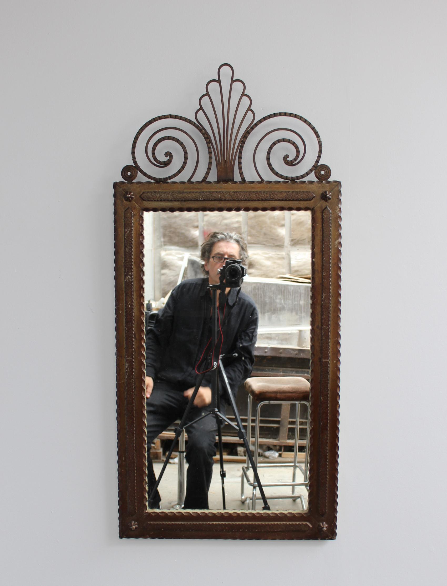 A fine French Art Deco mirror with a wrought iron frame.