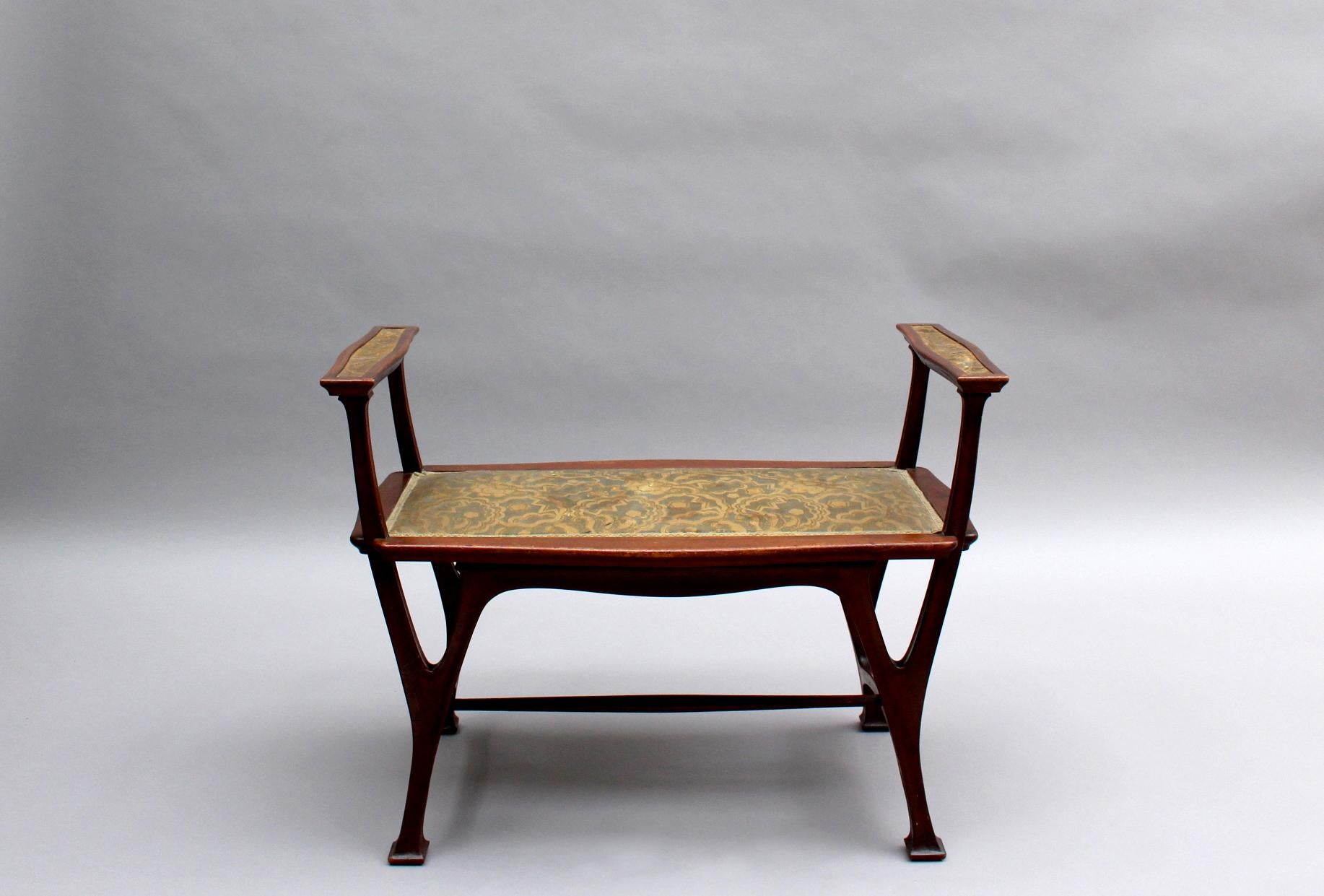 A fine French Art Nouveau upholstered mahogany bench.