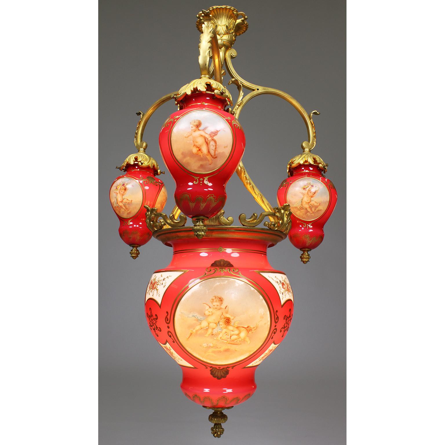 A very fine and rare French belle époque Baccarat opaline glass and gilt bronze six-light whimsical hanging lantern, chandelier. The finely chased three-arm gilt bronze frame, each arm surmounted with a pear-shaped hand painted shade decorated with
