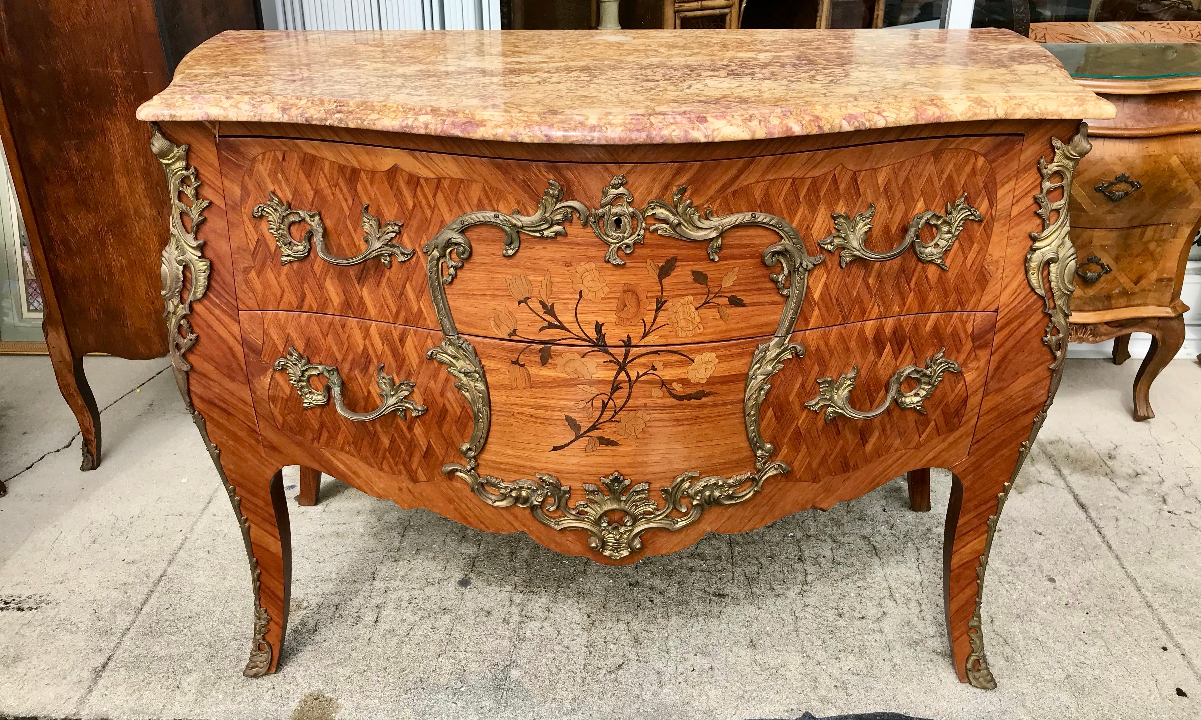 Generously scaled with exceptional and extensive marquetry inlays.
The bronze mounts are elaborate. Beautiful quality and workmanship.
The commode is fitted with a fine marble top.