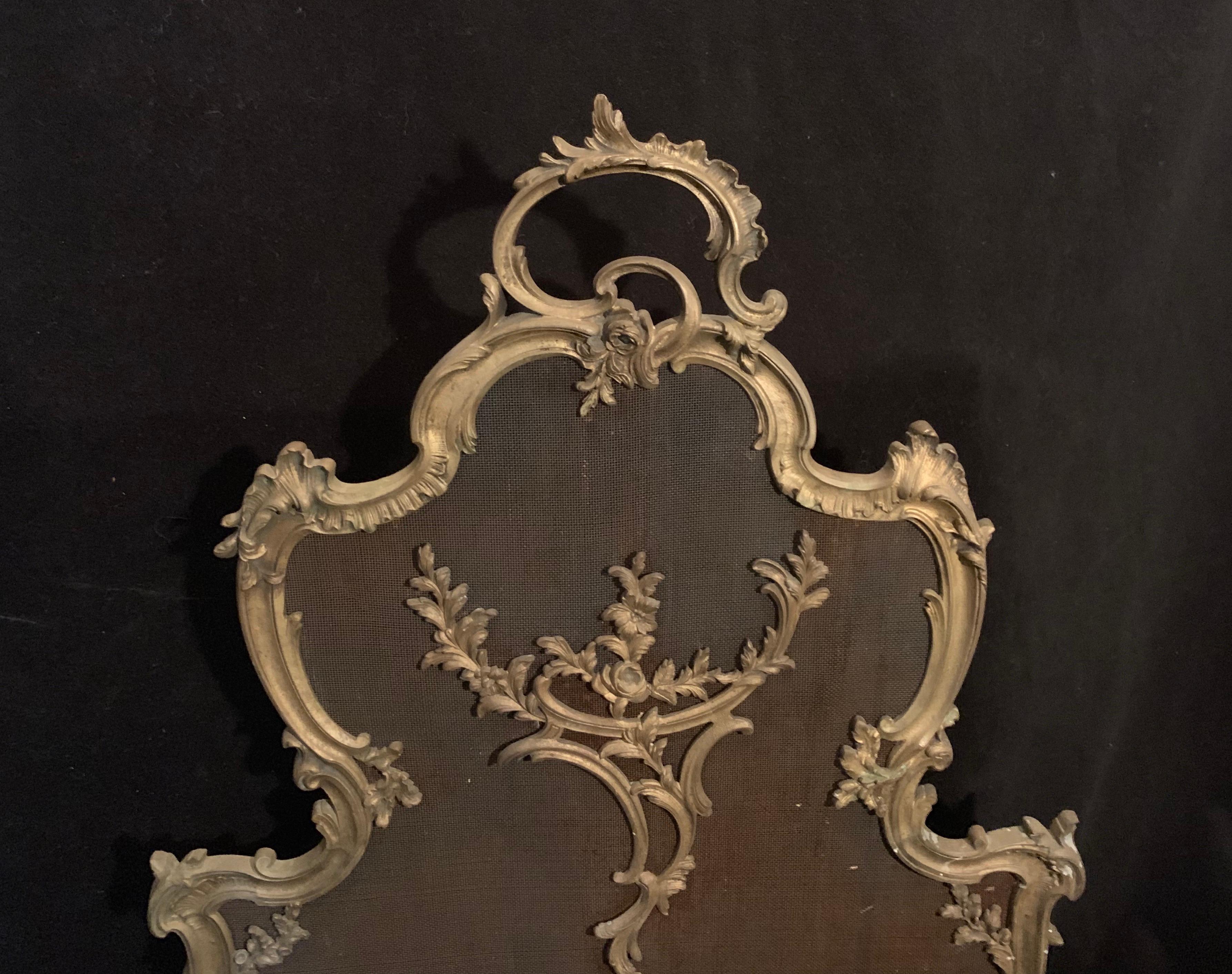 A wonderful French bronze fireplace ormolu fire place screen with flowers & garland in the manner of rococo.