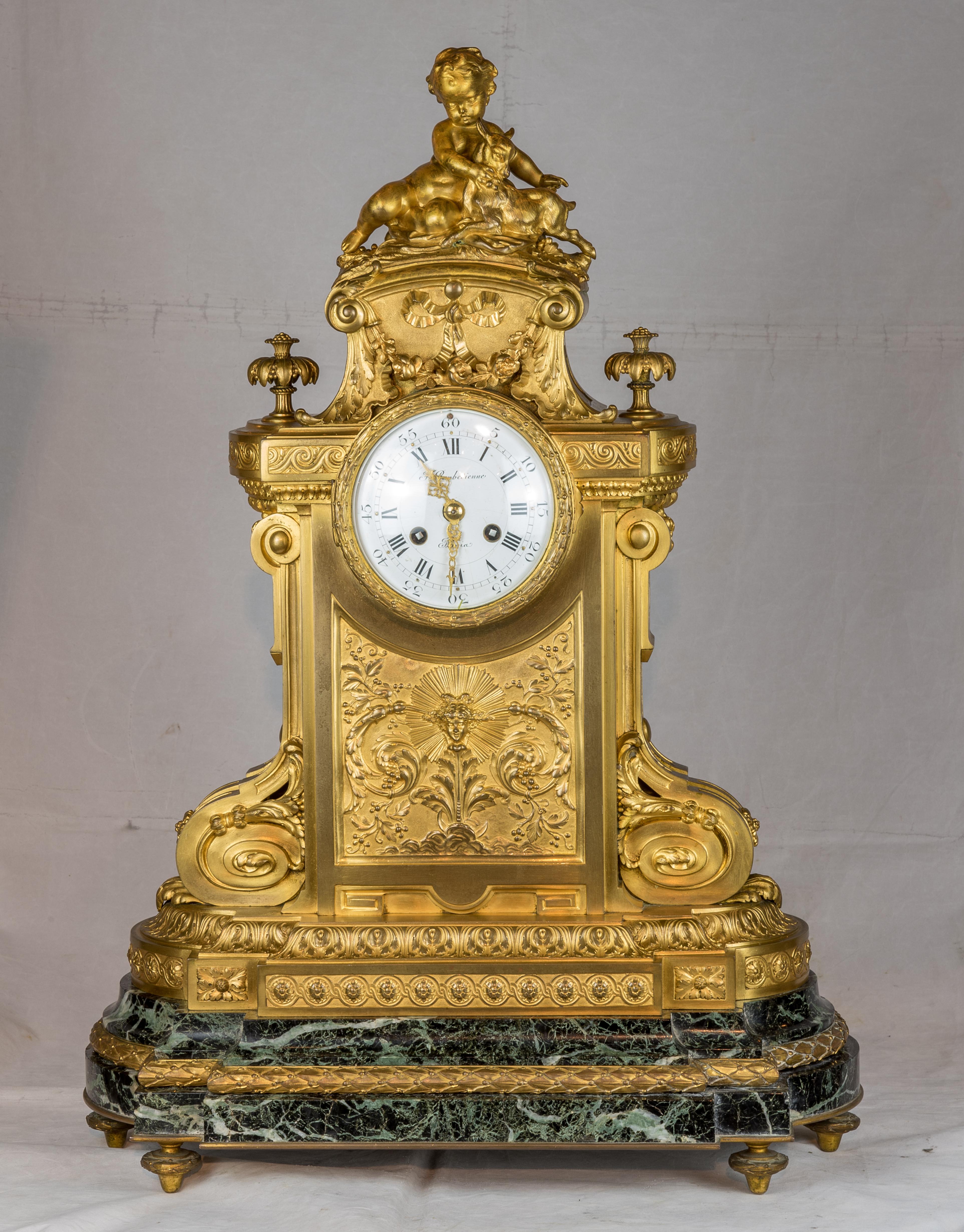 Surmounted on a French green marble, the clock with heavy dore bronze mounts. Marked on dial F. Barbedienne foundry. Accented with cherub & small goat atop, elaborate bronze decorative mounts throughout.

Origin: French
Date: 19th
