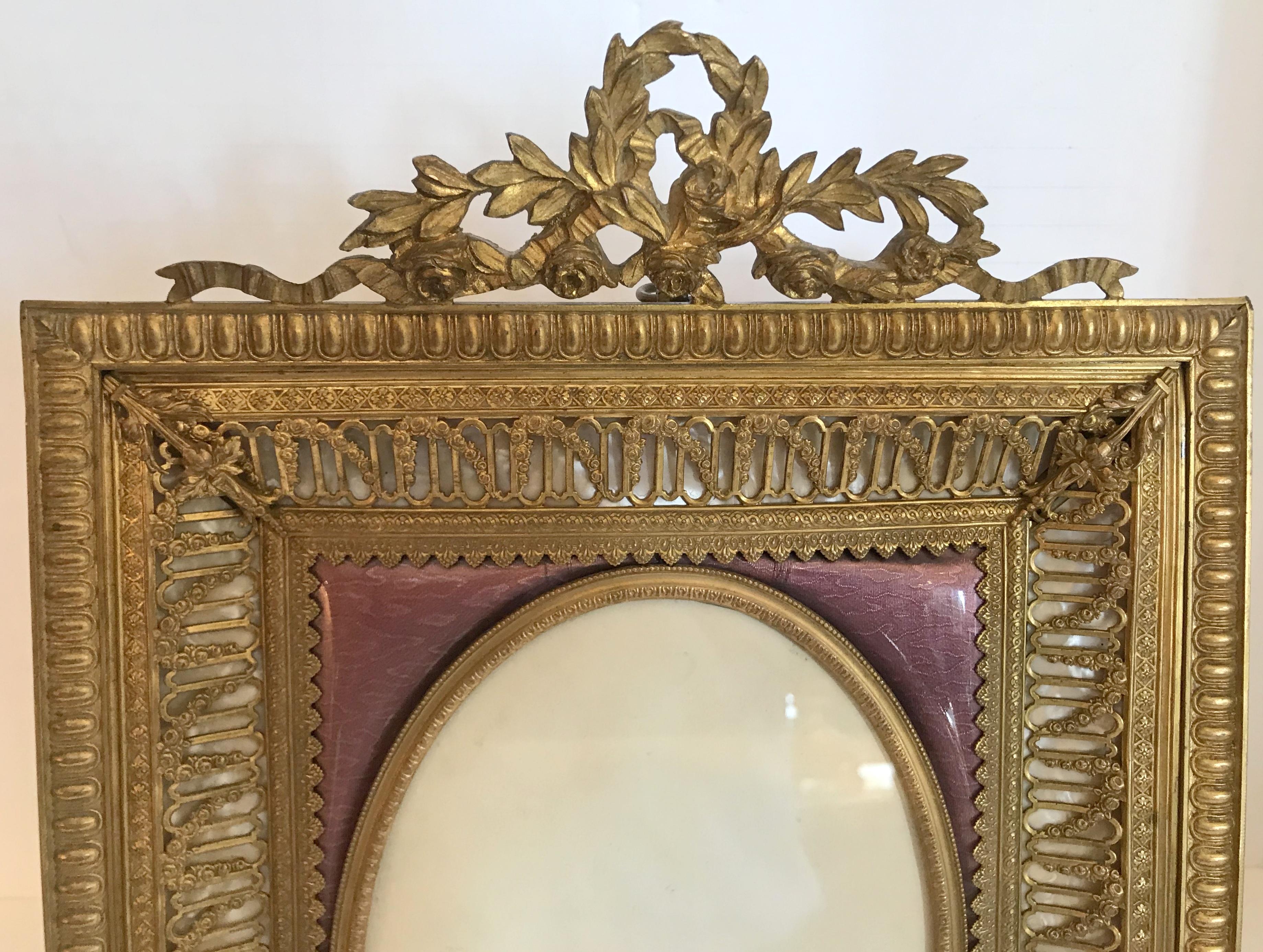 A fine French bronze ormolu purple Guilloche enamel and mother-of-pearl bow top. Floral and filigree large photo picture frame.
Measures: Actual frame is 10
