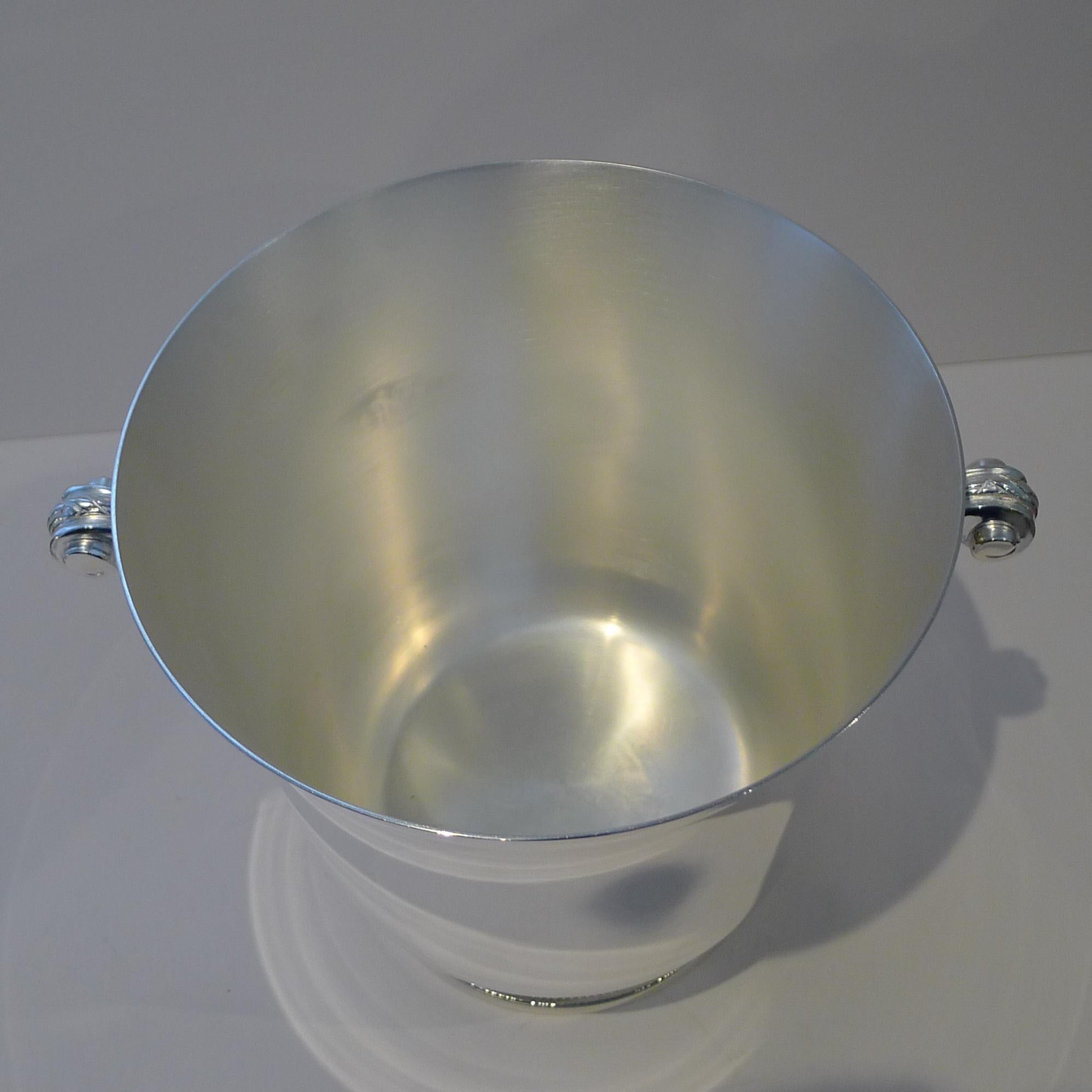 A wonderful vintage wine cooler / Champagne bucket made by the highly prized silversmith, Maison Ercuis.

The simple shape stands on a beaded foot and has two fabulous Art Deco style handles.  The underside is where the signature 