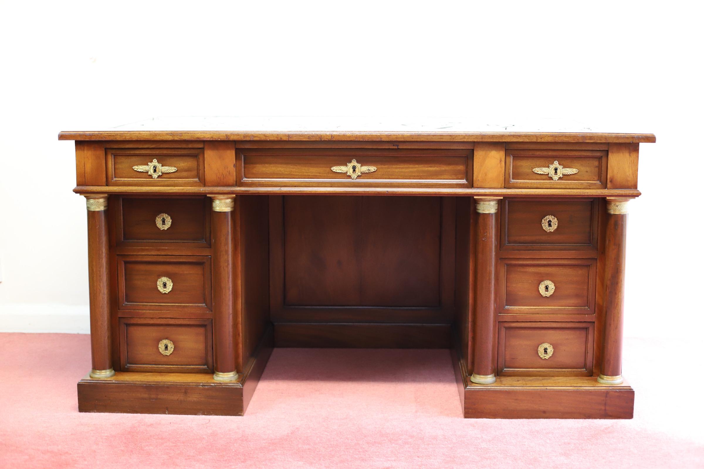 We delight to offer for sale this beautiful French Empire design gilt metal mounted oak twin pedestal desk, rectangular top with inset tooled writing surface above three frieze, three further drawers to each pedestal, divided and flanked by columns