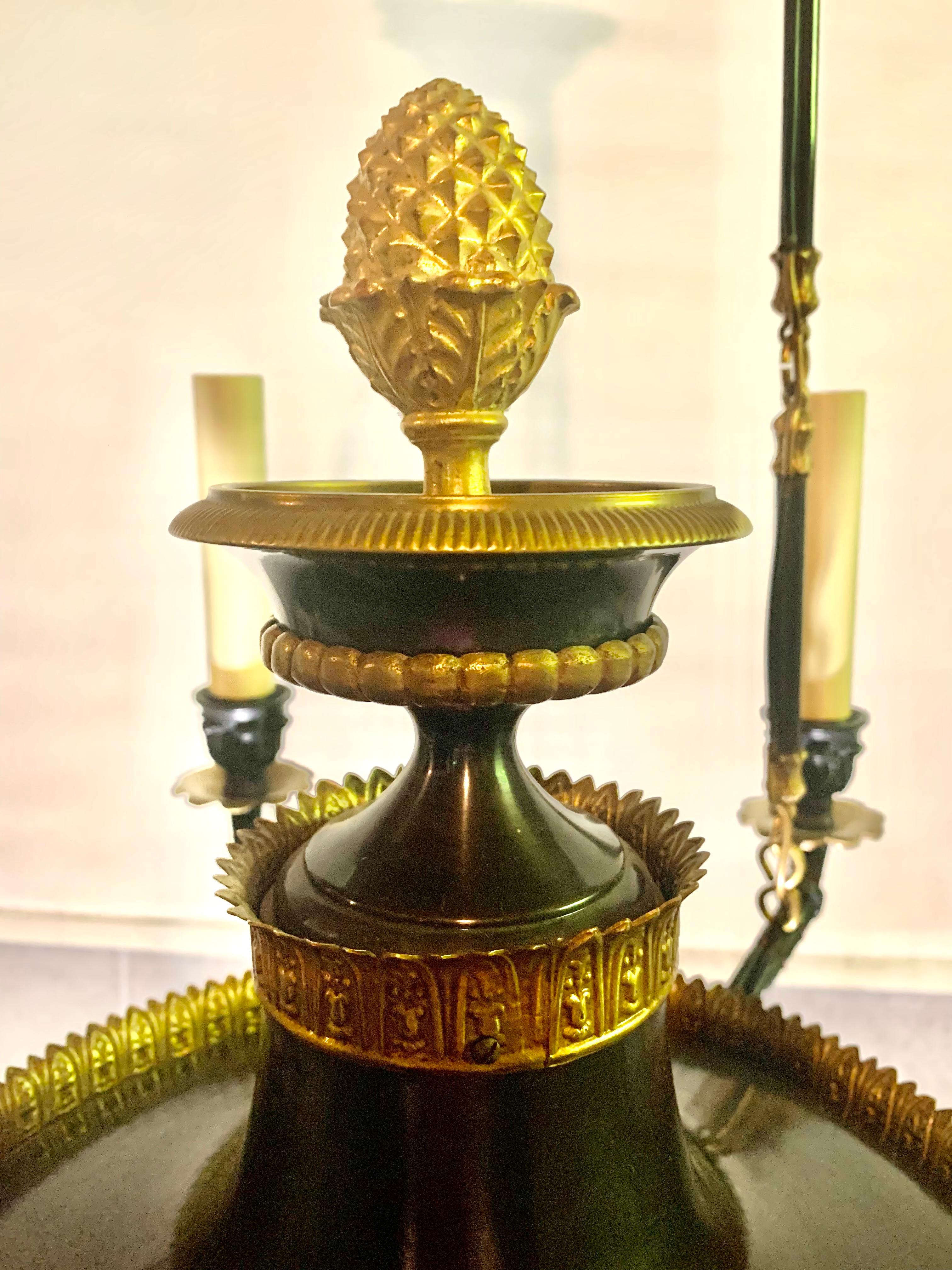 Classical French Empire gilt bronze, patinated metal and gilt wood six light chandelier.
19th Century
Well proportioned central gilt and patinated bronze Empire tazza with a large giltwood finial atop a circular gilt decorated patinated metal vessel