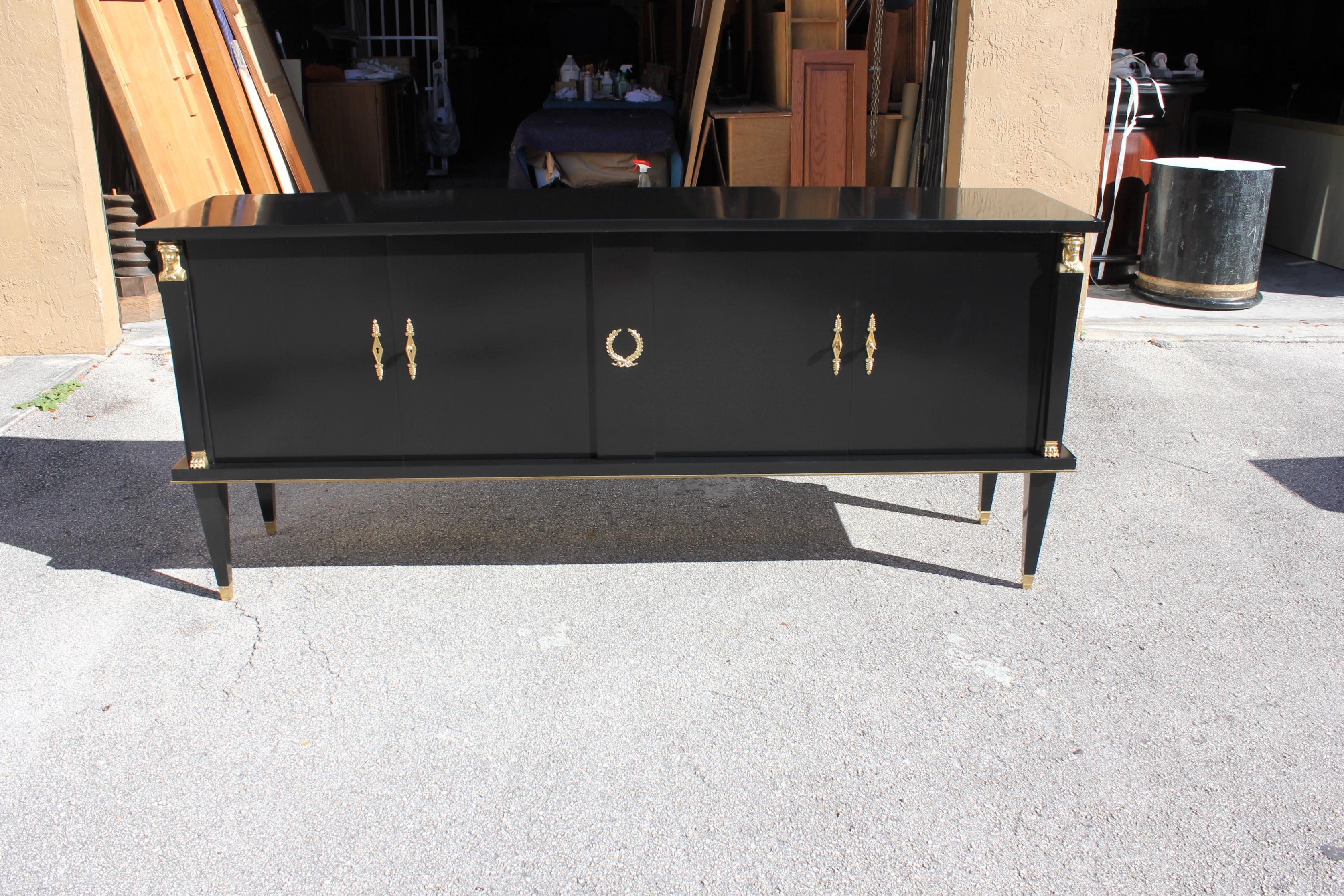 Long French Empire style antique sideboard or buffet made of mahogany, the mahogany wood has been ebonized and finished with a French polished high luster, the back of the sideboard are finish too, The sideboard or buffet has four doors, with