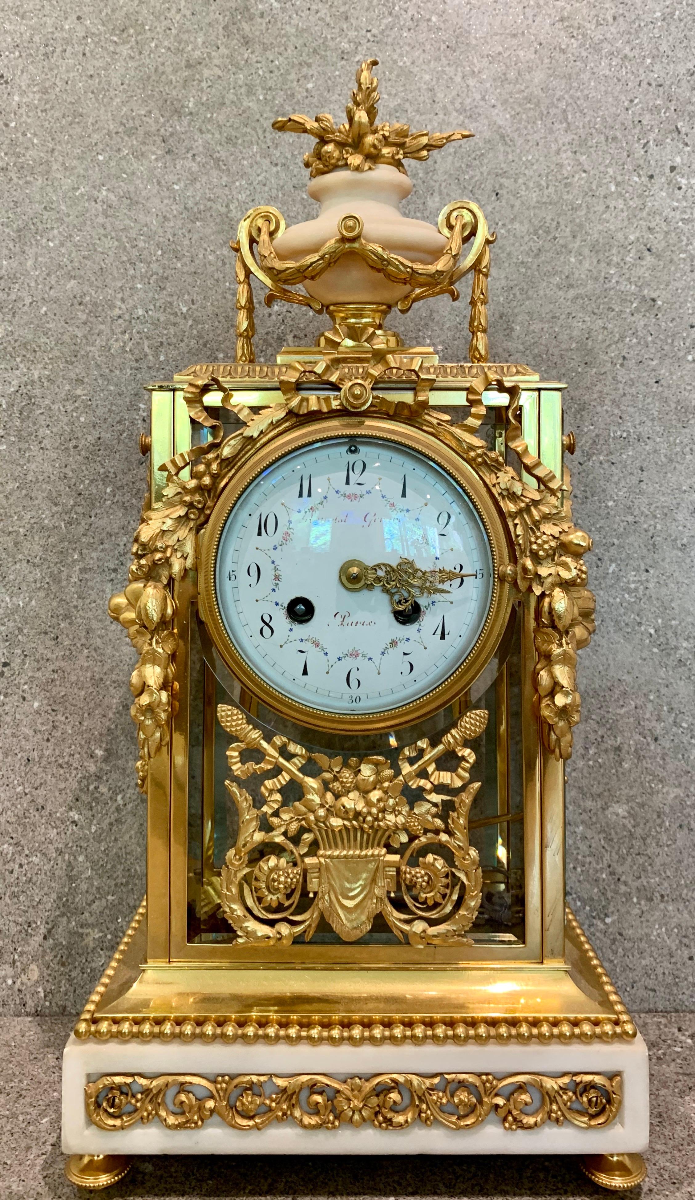 The superb clock with original gilding is of a vertical rectangular shape with an ormolu mounted urn to the top. The base of the clock is of white marble and has an ormolu frieze recessed into the marble ( rather than applied, a cheaper process).