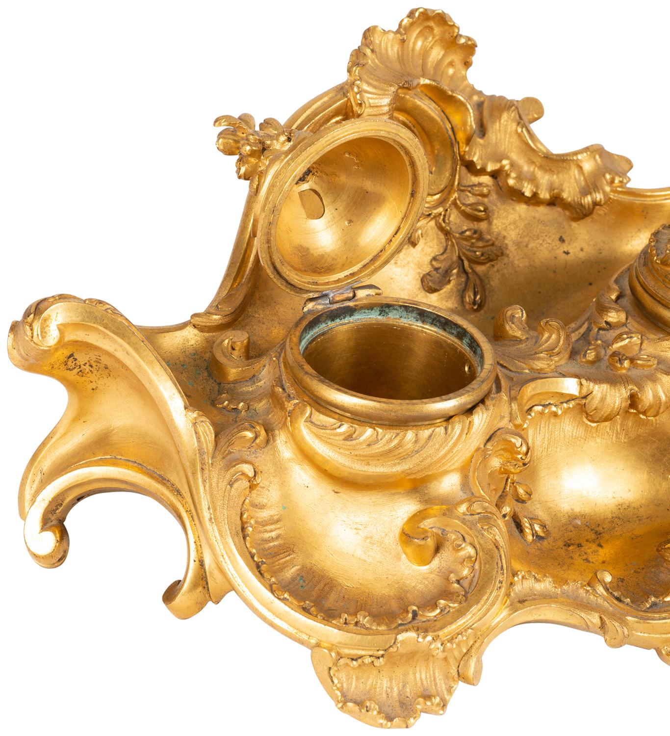 A fine quality late 19th century gilded ormolu inkwell Rococo influenced inkwell, having scrolling foliate decoration to the whole, two lidded inkwells, signed; Millet, Paris

Maison Millet (FrencH, FL. 1853-1918) Return To Glossary
Maison Millet