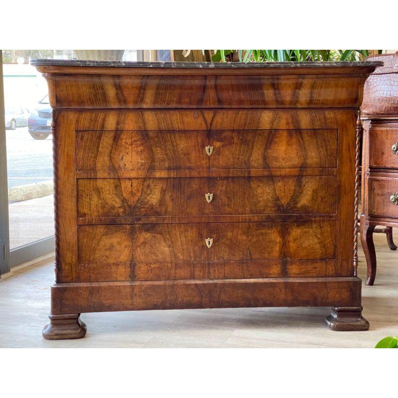Fine French Louis Philippe period walnut commode, mid 19th c., having rectangulardeep grey marble top, with a figured edge over beautifully figured wood, matched veneer case, fitted with ogee frieze drawer over three lower drawers, ribbon twist