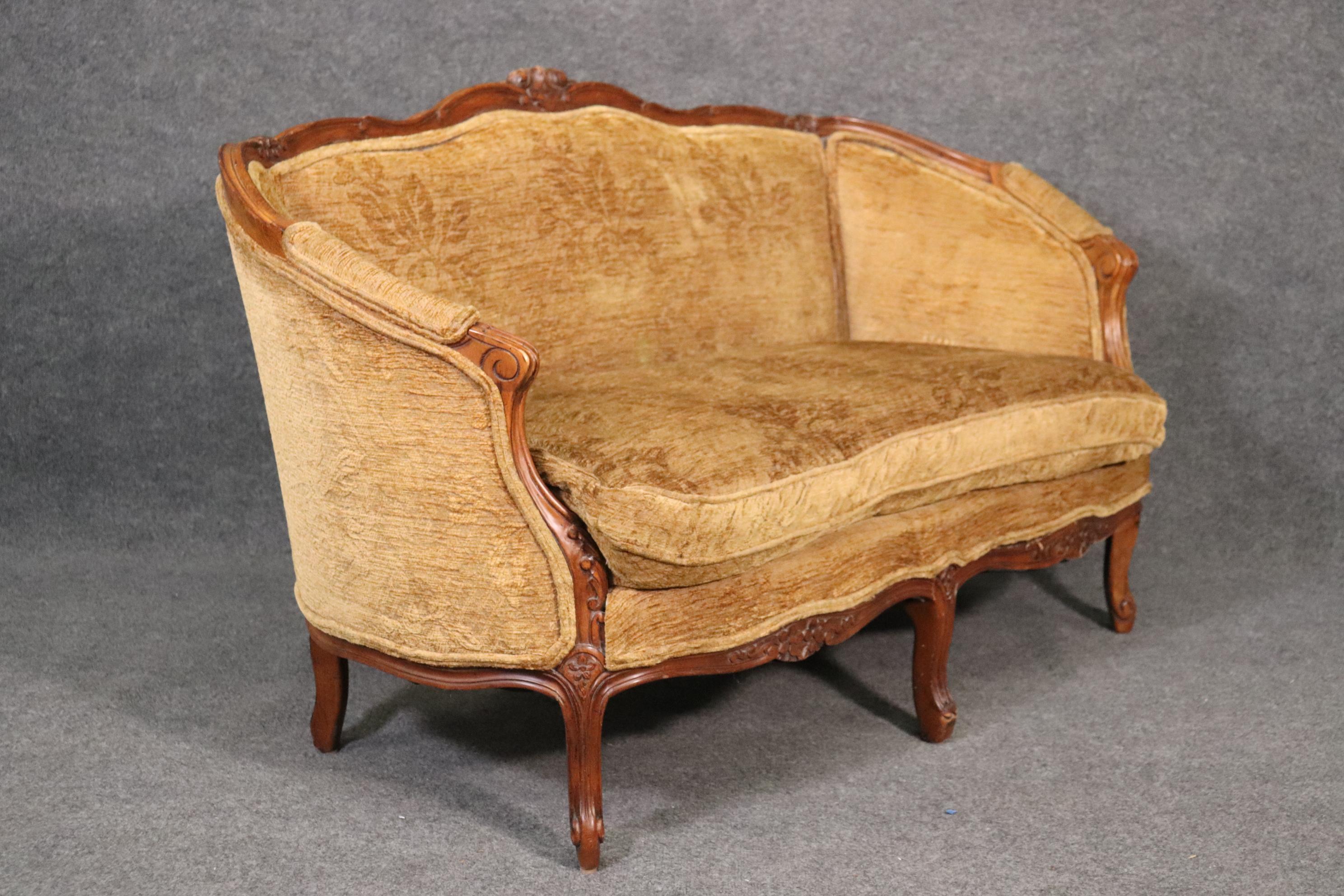 This is a gorgeous carved walnut Louis XV from France. The settee dates to the 1920s and is in good antique condition. The upholstery is original so it will show signs of wear and use. It is still very good though. The settee measures 60 wide x 33
