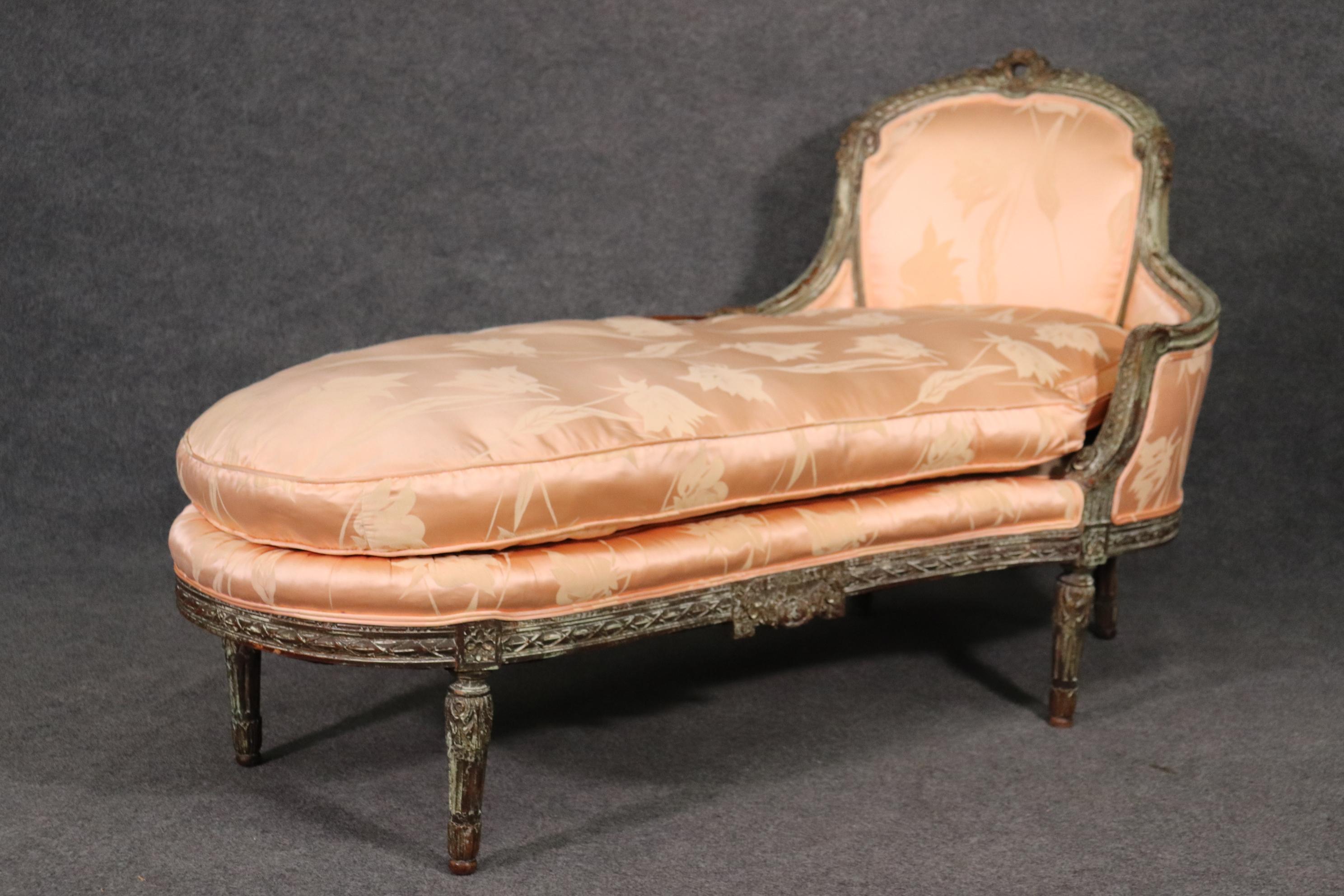 This is a truly beautiful chaise lounge. The upholstery is a gorgeous blush pink silk and the frame is beautifully and tastefully carved and finished as well. Dates to the 1890s era and is French. Measures 58.5 long x 27 wide x 35 tall and seat
